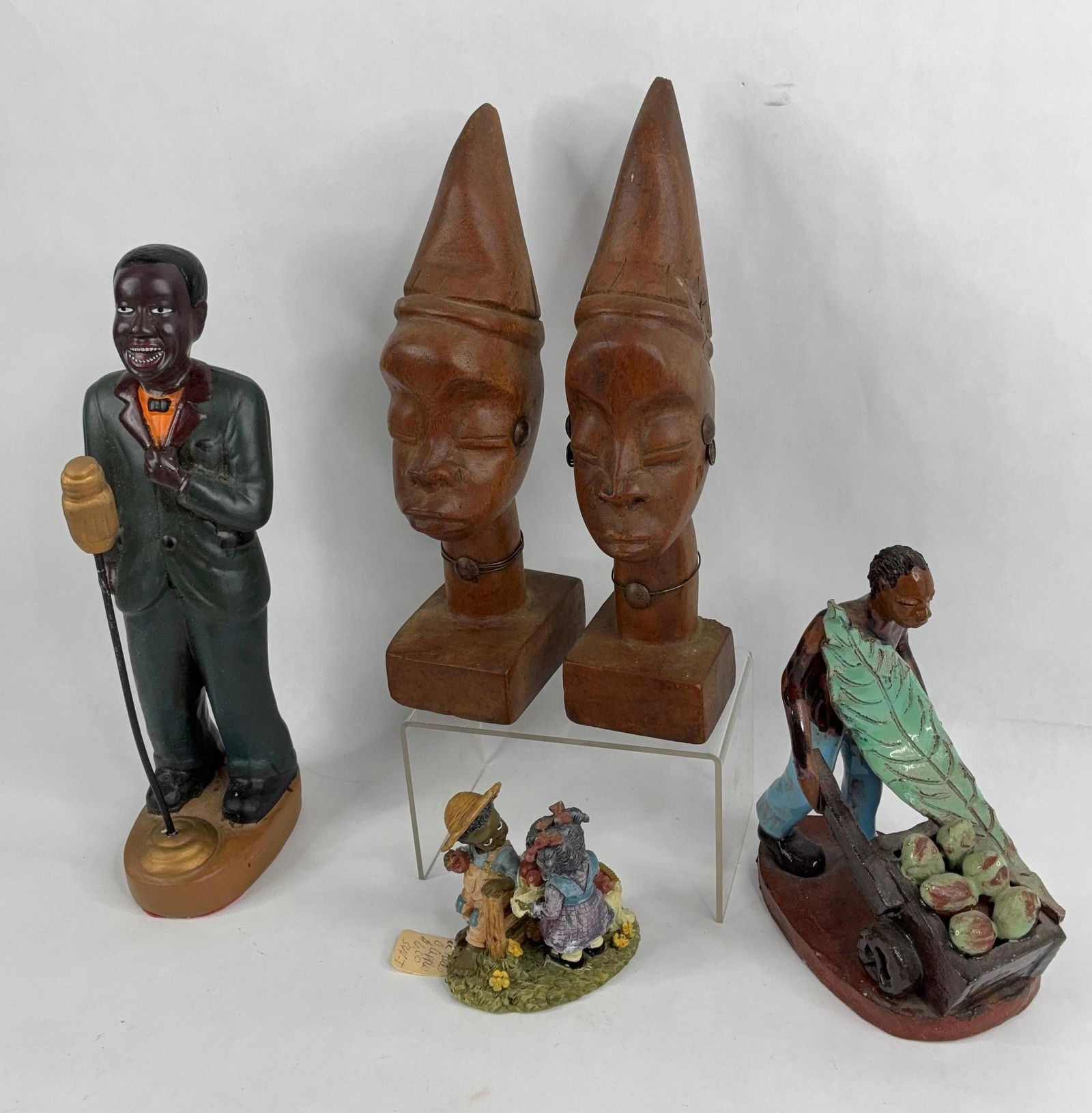 Americana lot: includes African tribal busts ,ceramic Jamaica signed fruit peddler ,kids with apples, and ceramic singer