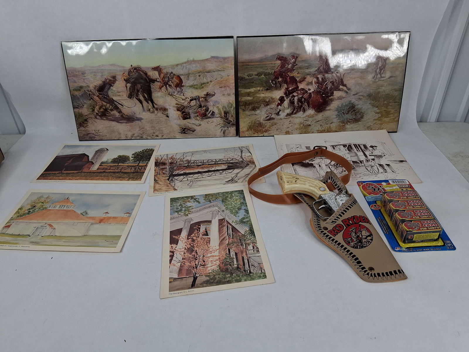 Red Ryder cap gun,1000 caps ,CM Russell lithos and more: include red Ryder cap gun , caps ,2 CM Russell litho and 5 other lithos see photos
