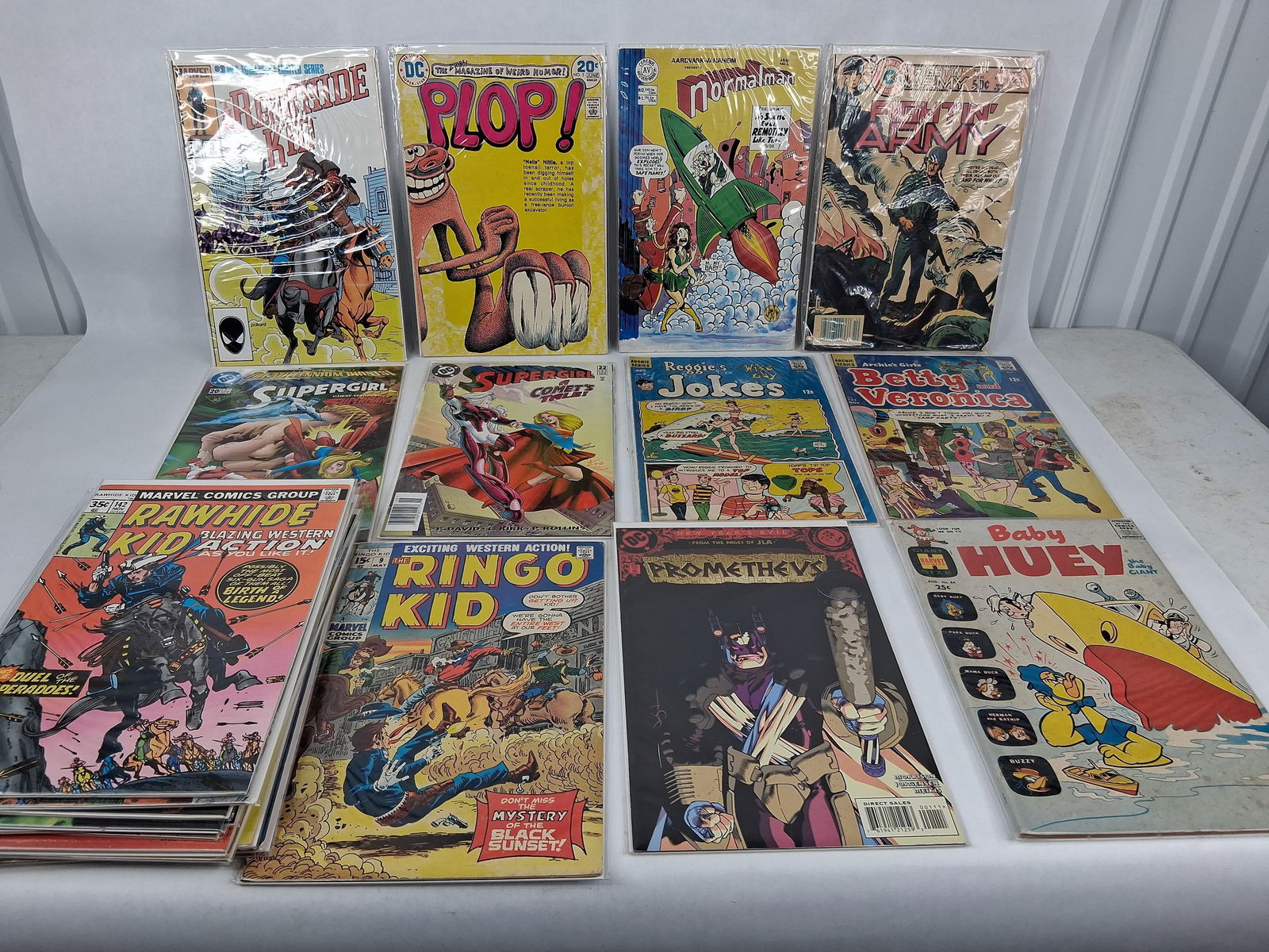 Ringo Kid ,Batman Super girl and more DC marvel comic books: 22 books all are in good condition with protective sleeve and card board backers