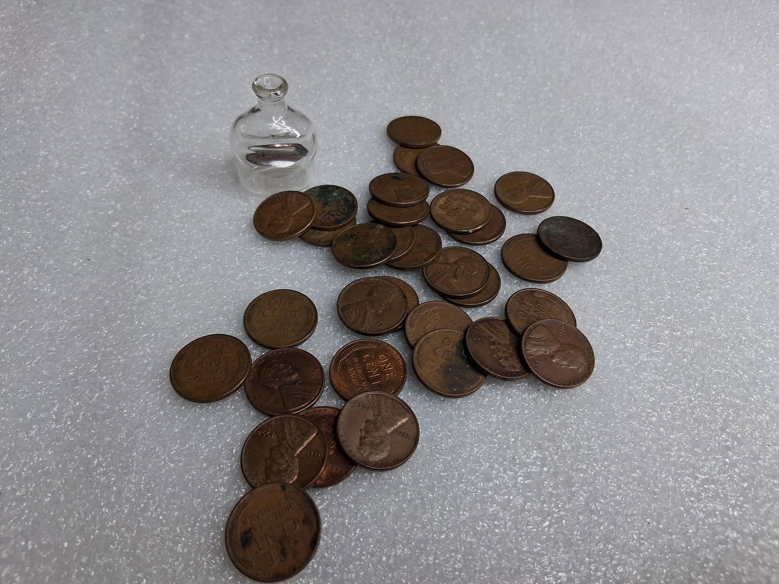 33 Unsearched Lincoln head wheat pennies and 1964 penny in glass bottle.: .