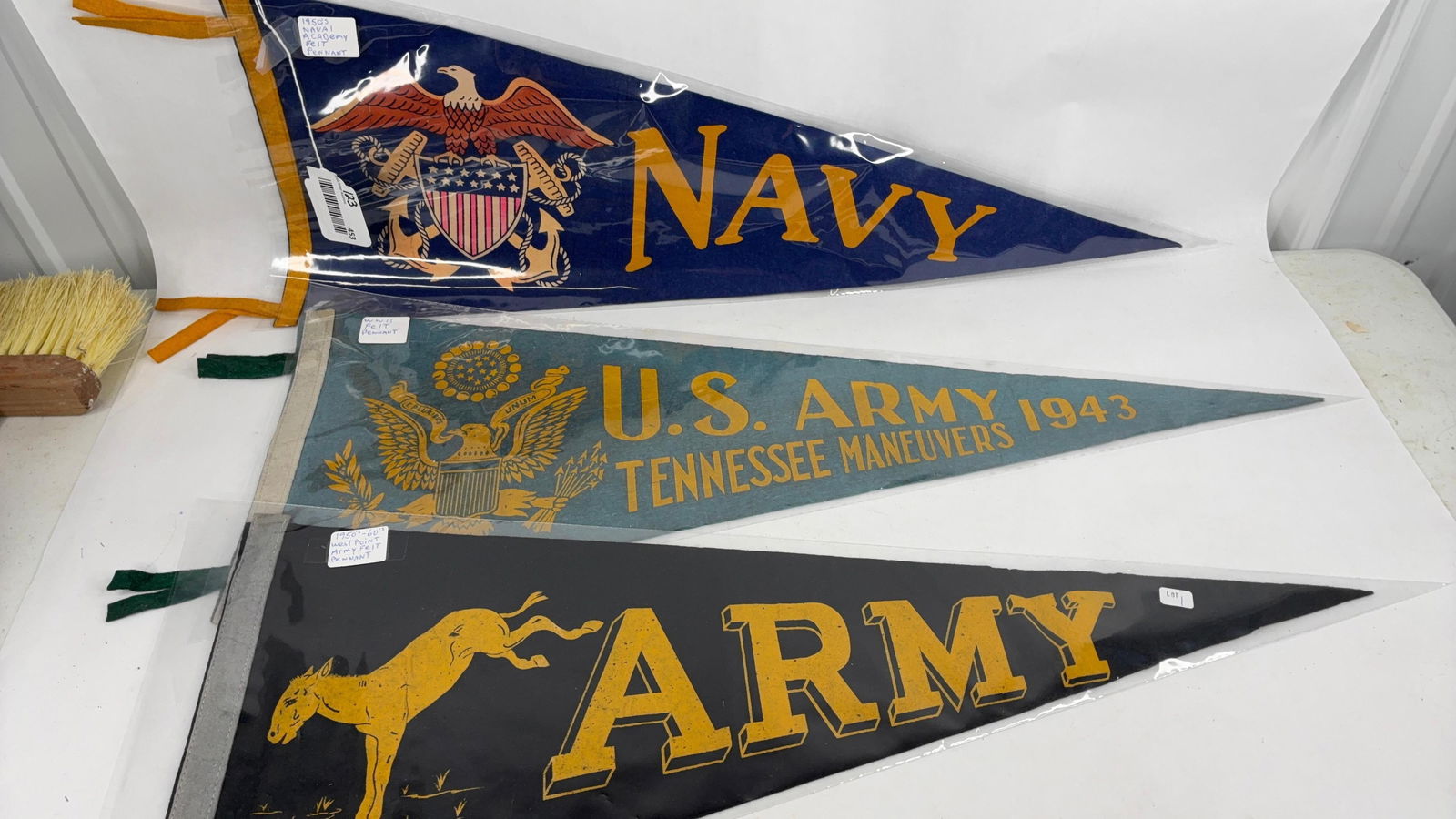 WW11 and 1950th Army & Navy felt pendants: 1950th Navy ,1950th-60th west point Army and WW11 pendants in plastic sleeve and in good condition