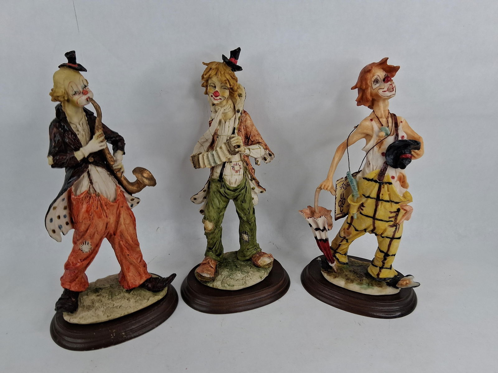Hobo Clown Musicians: Three unique collectors edition figures, each is approx 11.5 to 12 inches tall. By R. Feiolmea. 