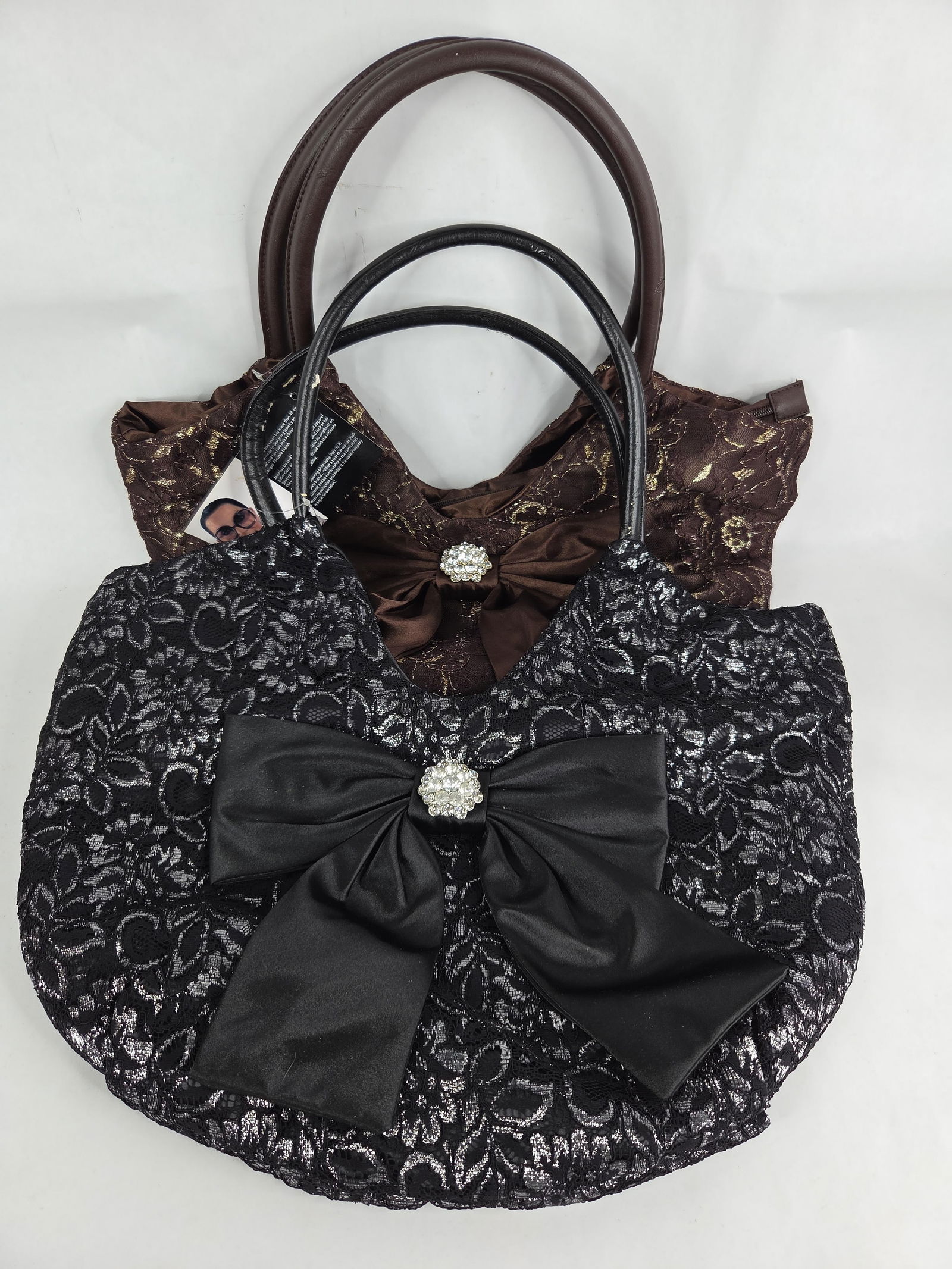 Black and brown Joan Boyce hand bags: both have original tags black hand bag has some flaking on handles