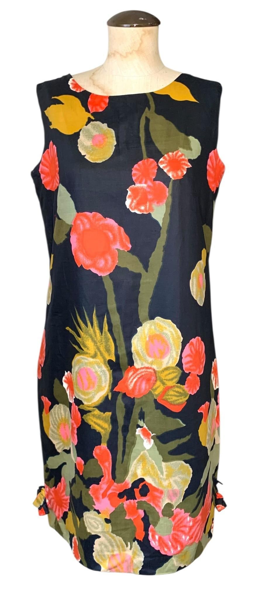 Mid Century Custom Made Sleeveless Floral Print Vintage Shift A-Line Dress: Appearing Unworn with working metal zipper and hook/eye closure at the rear, fully lined, a safety pin holds the bow detail at each hem edge, Incredible floral print fabric with minor storage wrinklin