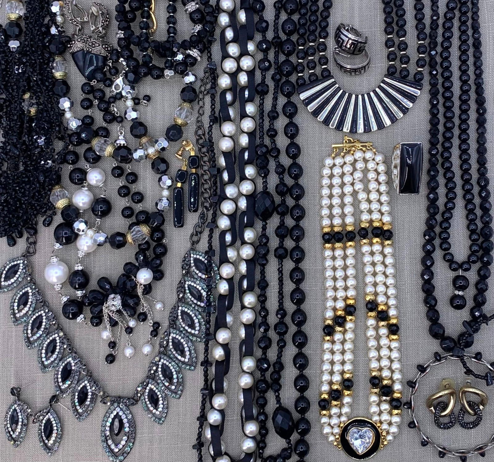 1920s to 90's Dramatic 27 pc Raven Black, Faux Pearl Rhinestone Costume Jewelry Collection: Flapper era glass bead necklaces, grosgrain ribbon woven faux pearls, draped statement necklaces, glittering rhinestones (some missing), dramatic collar necklaces, oversize black glass beads, pierced