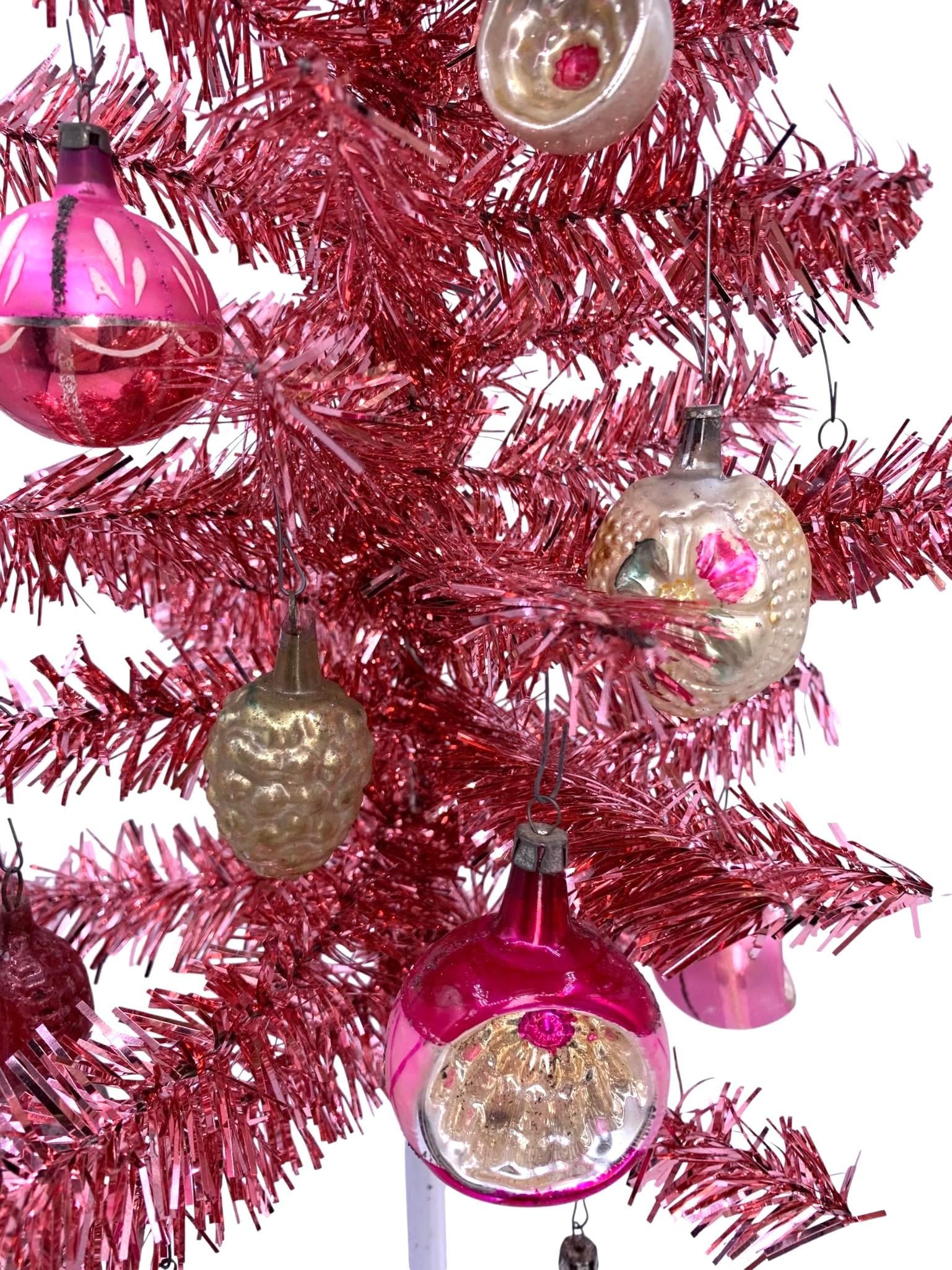 26 pc Vintage Miniature Metallic Watermelon Pink Tinsel Tree and Antique to MCM Glass Ornaments: 24 antique to vintage mercury glass ornaments, glittered, indent and hand painted, a strand of antique tinsel garland, one early Poland ornament paperboard box included and a 21" table top size tree w