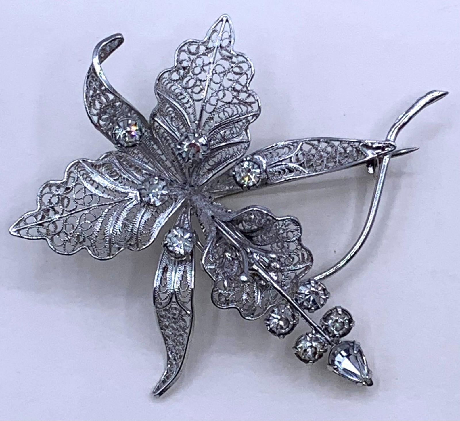 Superb Italian Sterling Silver Filigree Vintage Openwork Jeweled Rhinestone Orchid Lapel Pin: Marked Sterling, Italy, J G Sterling, exquisite filigree petals and leaves, sparkling rhinestone accents, 2 1/2" x 2 3/8", 9.9 gram weight.
