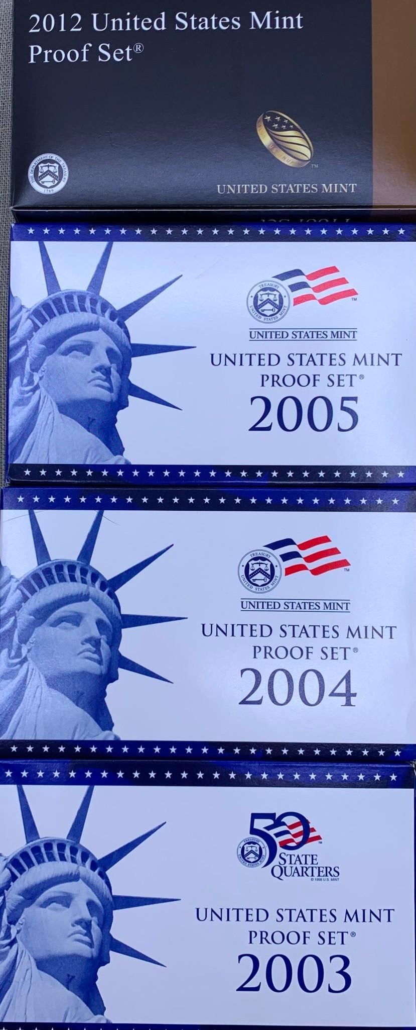 4 Boxes 2003, 2004, 2005 2012 United States Mint Proof Coin Sets US Mint Coin Storage Box: * 2003 US mint proof set containing two cases of coins, original box and paperwork* 2004 US mint proof set containing two cases of coins, original box and paperwork* 2005 US mint proof set containing