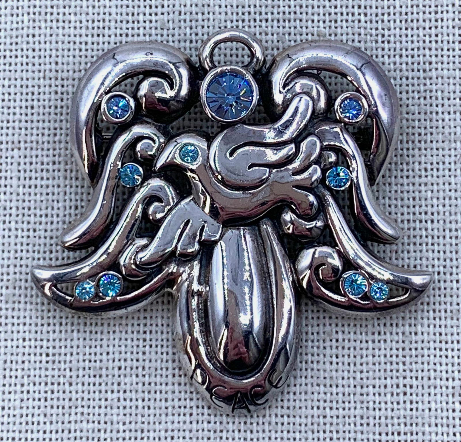 Large 20.9 Gram Sterling Silver BARSE Peace Angel Brooch Pendant: 925 BARSE hallmark, hefty 20.9 gram weight, working pin with chain loop, sparkling blue crystal accents, 1 7/8" x 1 7/8".