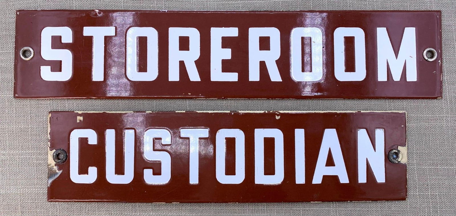 Pair Art Deco Porcelain Enamel Metal School CUSTODIAN, STOREROOM, Signs: Cocoa and White porcelain, metal grommets, 12" x 2 1/2" and 10" x 2 1/2", scattered age and old paint to the porcelain edges, hefty in weight.