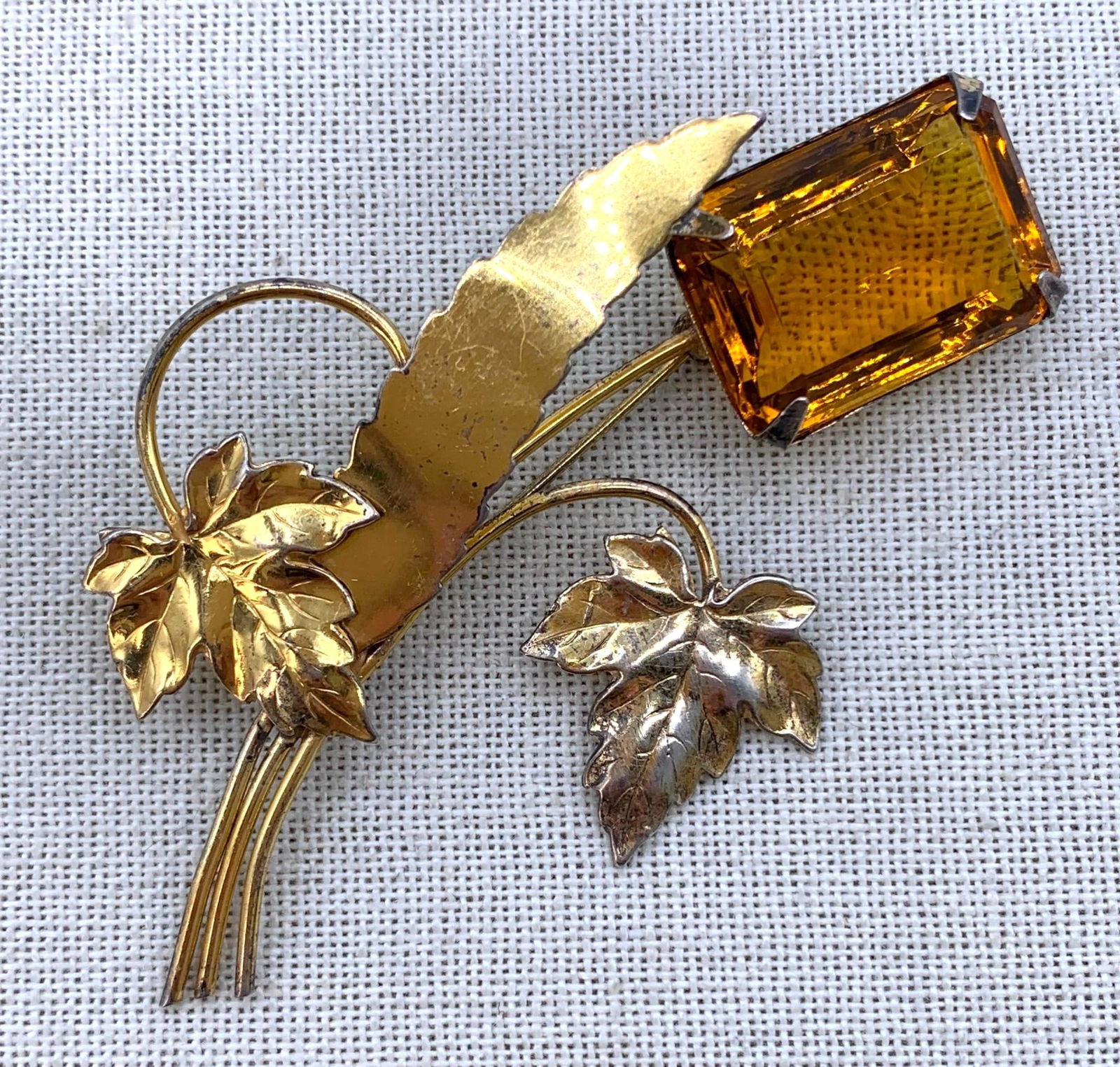 Large Mid Century Vintage Gilded Sterling Silver Citrine Glass Gemstone Brooch: Large 25x18mm faceted citrine hued glass gem, curled stem and delicate leaves, working pin, STERLING mark, 3 1/2" x 2 1/4", 17.6 gram weight.nbsp;