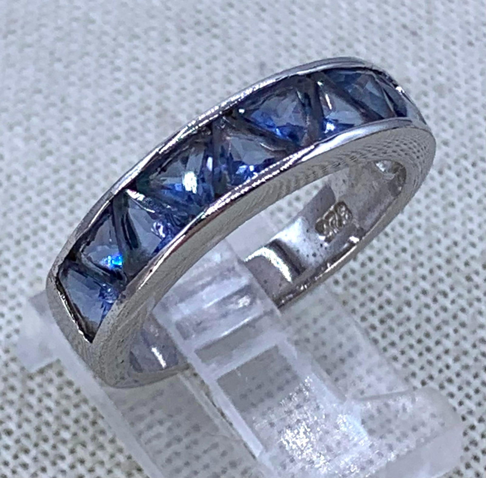 Sterling Silver Channel Set Trillion Cut Cornflower BlueTanzanite Ring: 925 hallmark, size 8, 4.6 gram weight, fantastic sparkle to the Tanzanite gemstones.