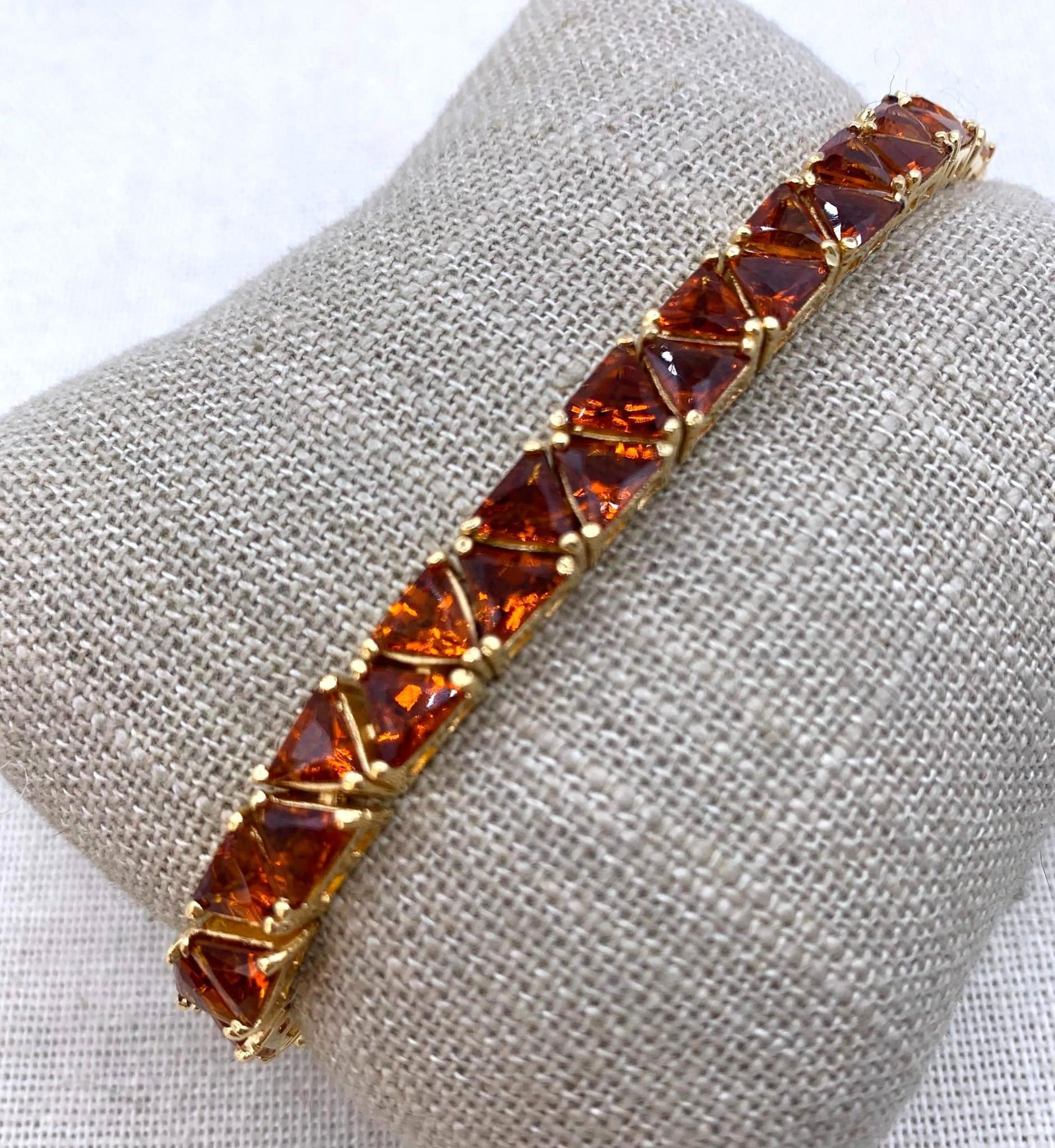 23 Carat Gold Vermeil over Sterling Silver Trillion Cut Citron CZ Gemstone Tennis Bracelet: 925 hallmark, working closure and safety clasp, 46 approx. 5x5mm warm honey citron CZ gems, one gem has a flake to the surface, Superb sparkle, 21.5 gram weight, 7 5/8" length.