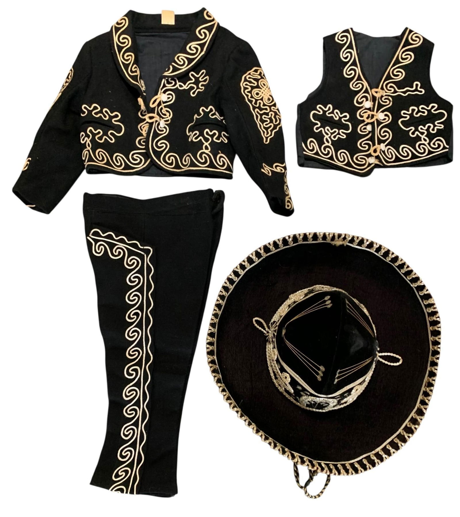 Vintage Mid Century 3 pc Child Size Black Wool Mexican Charro Suit with Velvet Sombrero Hat: Ornate passementerie trim on the black wool suit, button fly, petite usable pockets in the vest, jacket and pants, sequin trimmed sombrero, paper tag remains stapled to the nape of the jacket, appeari