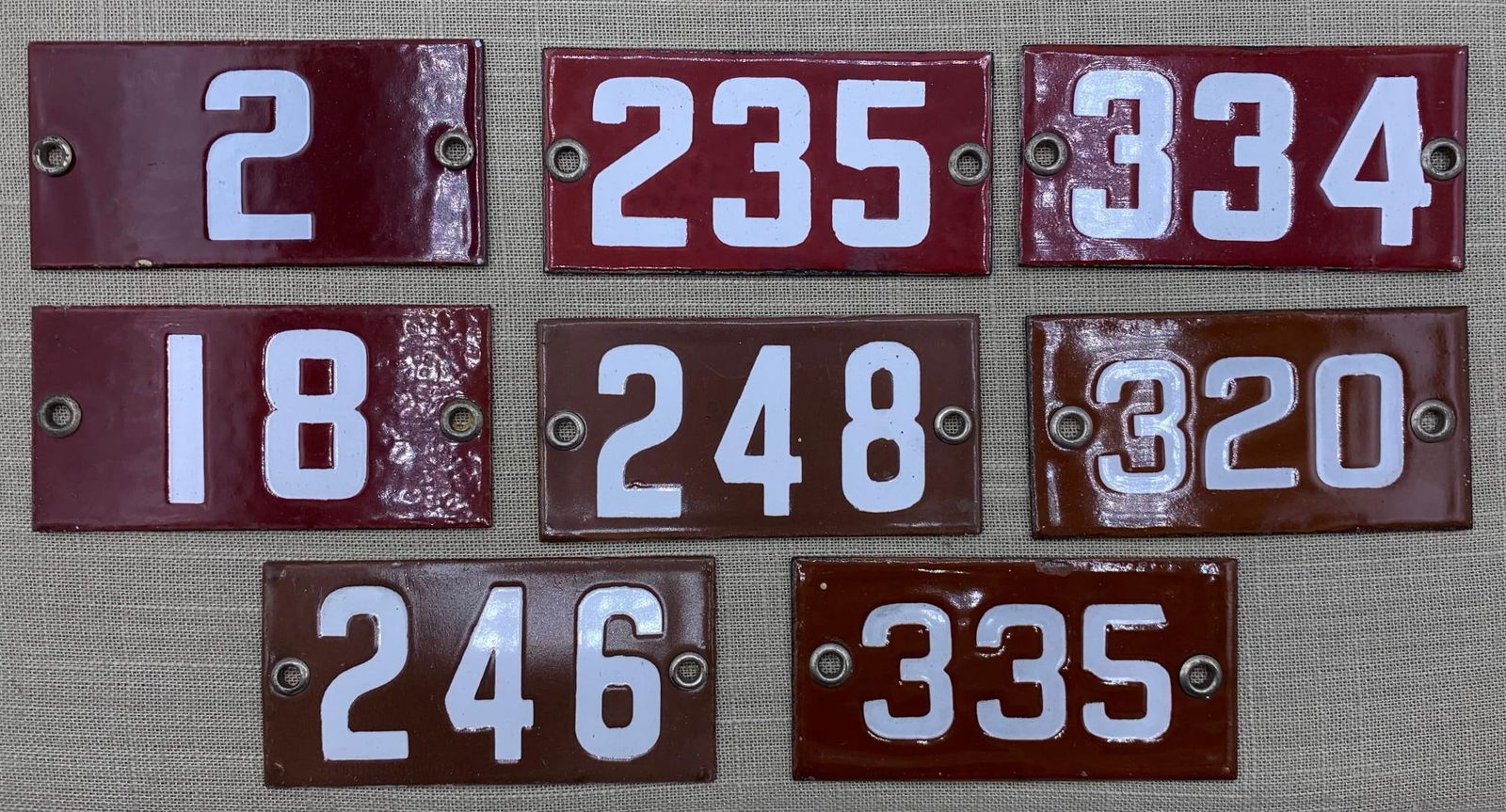 8 Vintage 1920s Porcelain School Classroom Number Signs: Hefty in weight with metal grommets. light age and wear to the porcelain, 4" x 2".