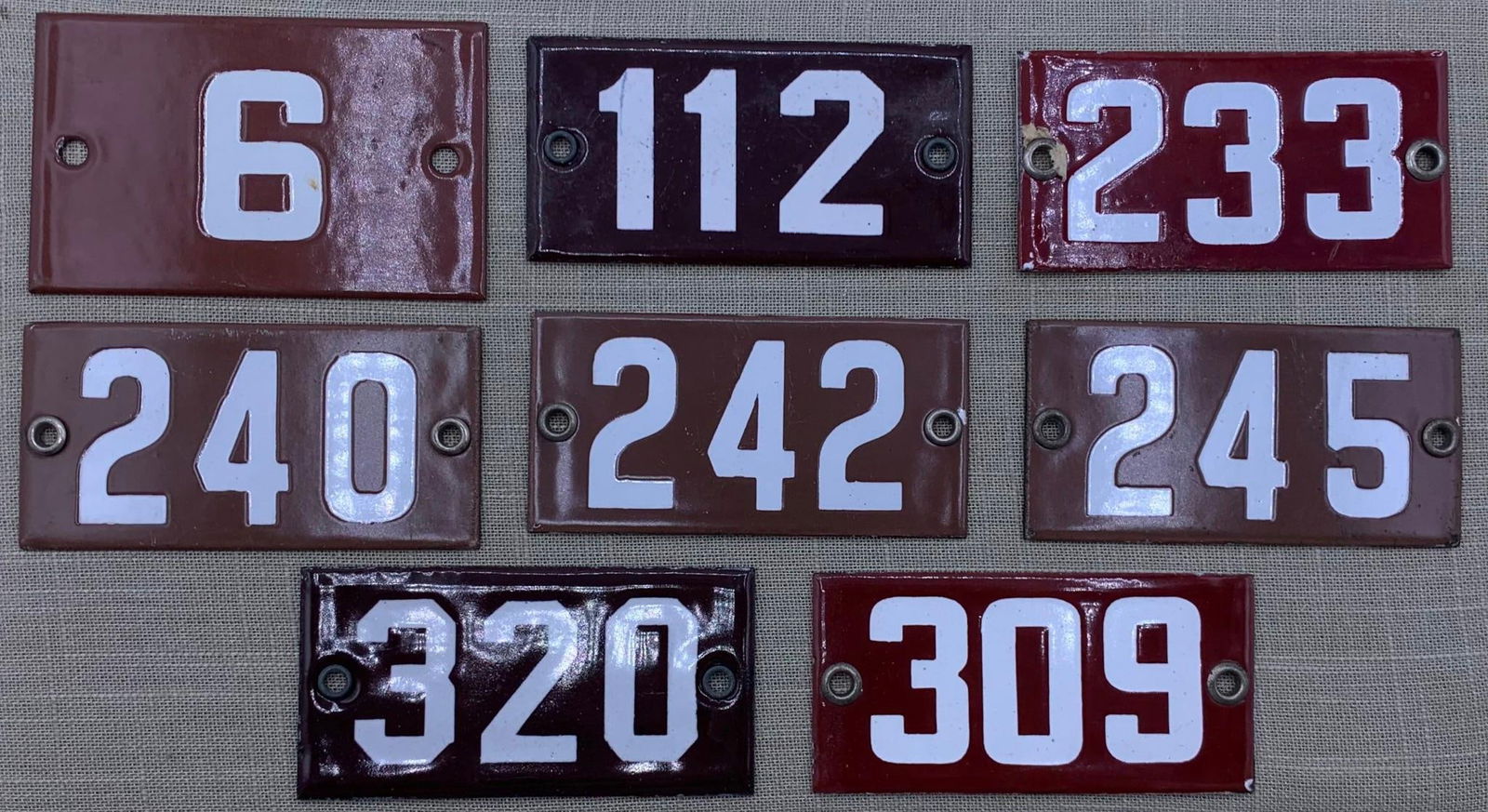 8 Vintage 1920s Porcelain School Classroom Number Signs: Hefty in weight with metal grommets. light age and wear to the porcelain, 4" x 2".