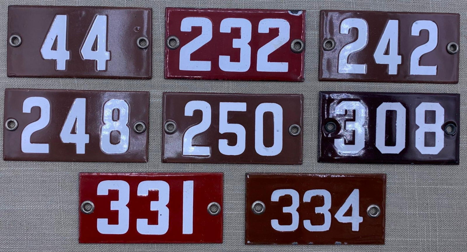 8 Vintage 1920s Porcelain School Classroom Number Signs: Hefty in weight with metal grommets. light age and wear to the porcelain, 4" x 2".