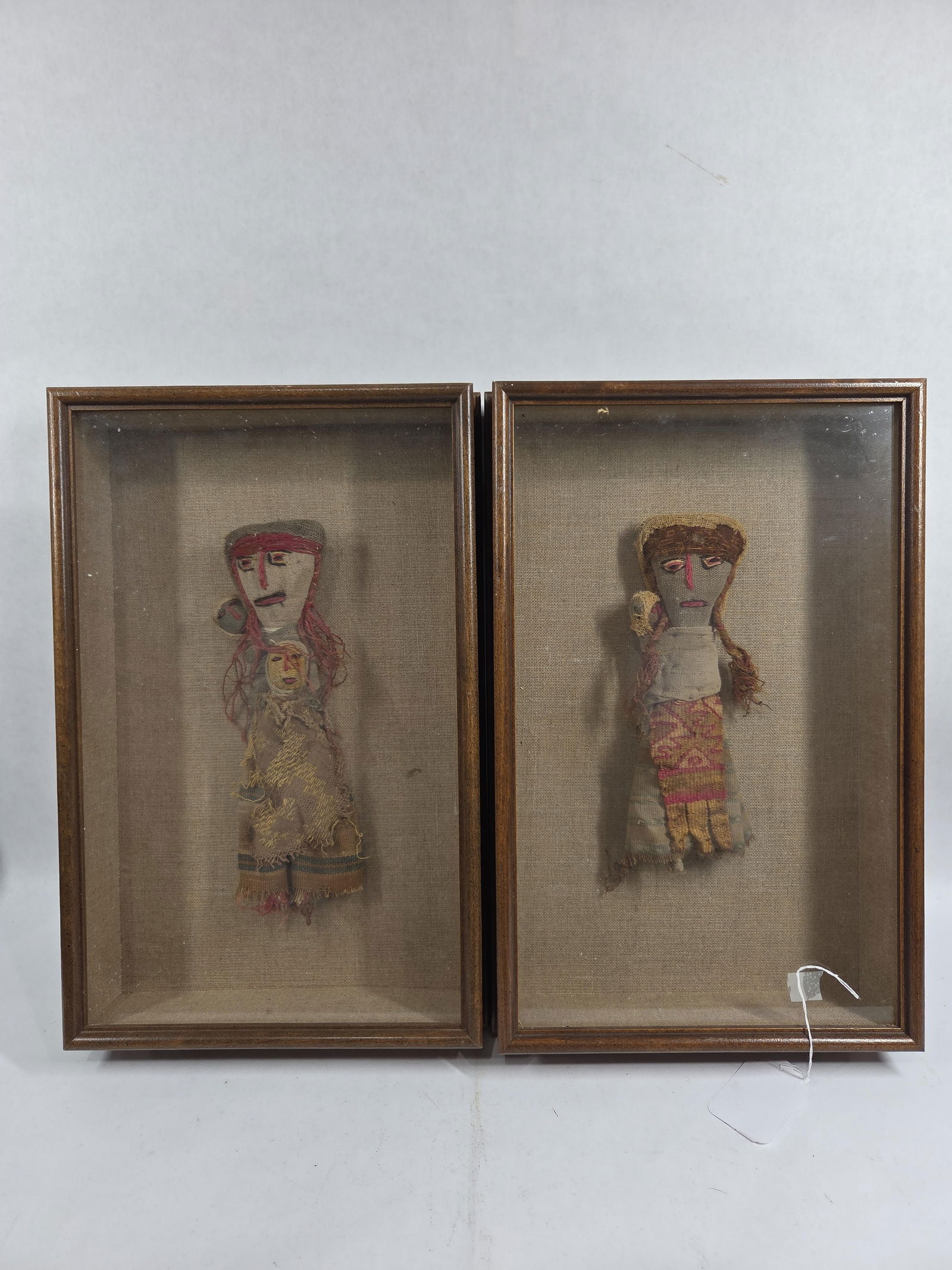Early RARE Chancay Peruvian Burial or Funerary Dolls in Framed Shadow Boxes: These dolls are hand crafted with original textiles from the pre Columbian Chancay Culture 1000-1460 CE of Peru which were found in burial sites this lot of 2 preserved in framed shadow boxes are