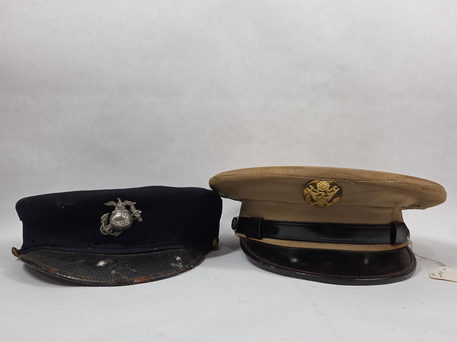 United States Marines & Army Officers Caps: WW2 Era. Marines hat shows some scuffing to leather brim and cracking to inside.