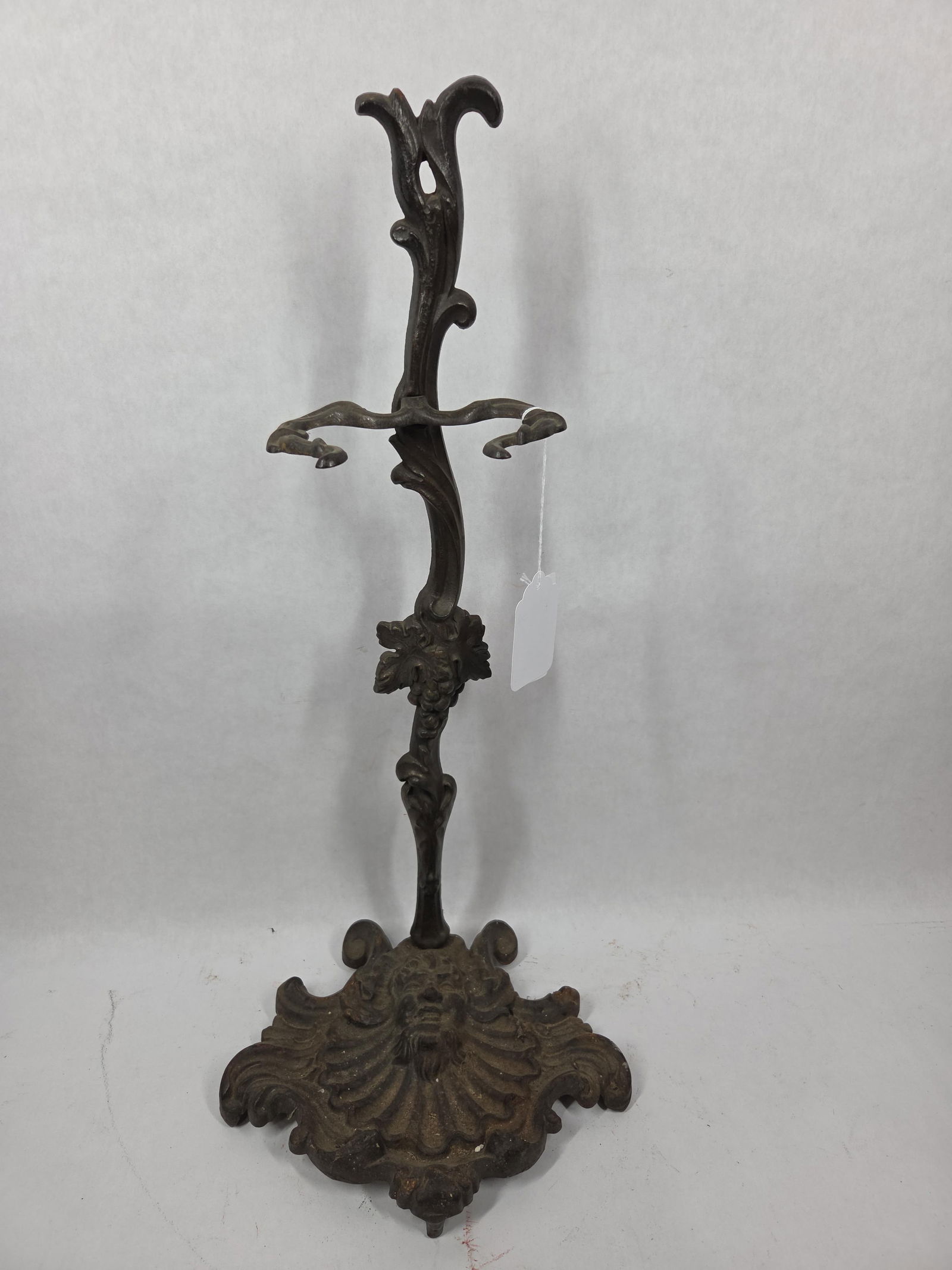Mystical Cast Iron Umbrella Stand: Featuring a elf type face to bottom and grape and leaf designs to body. 22 inches tall