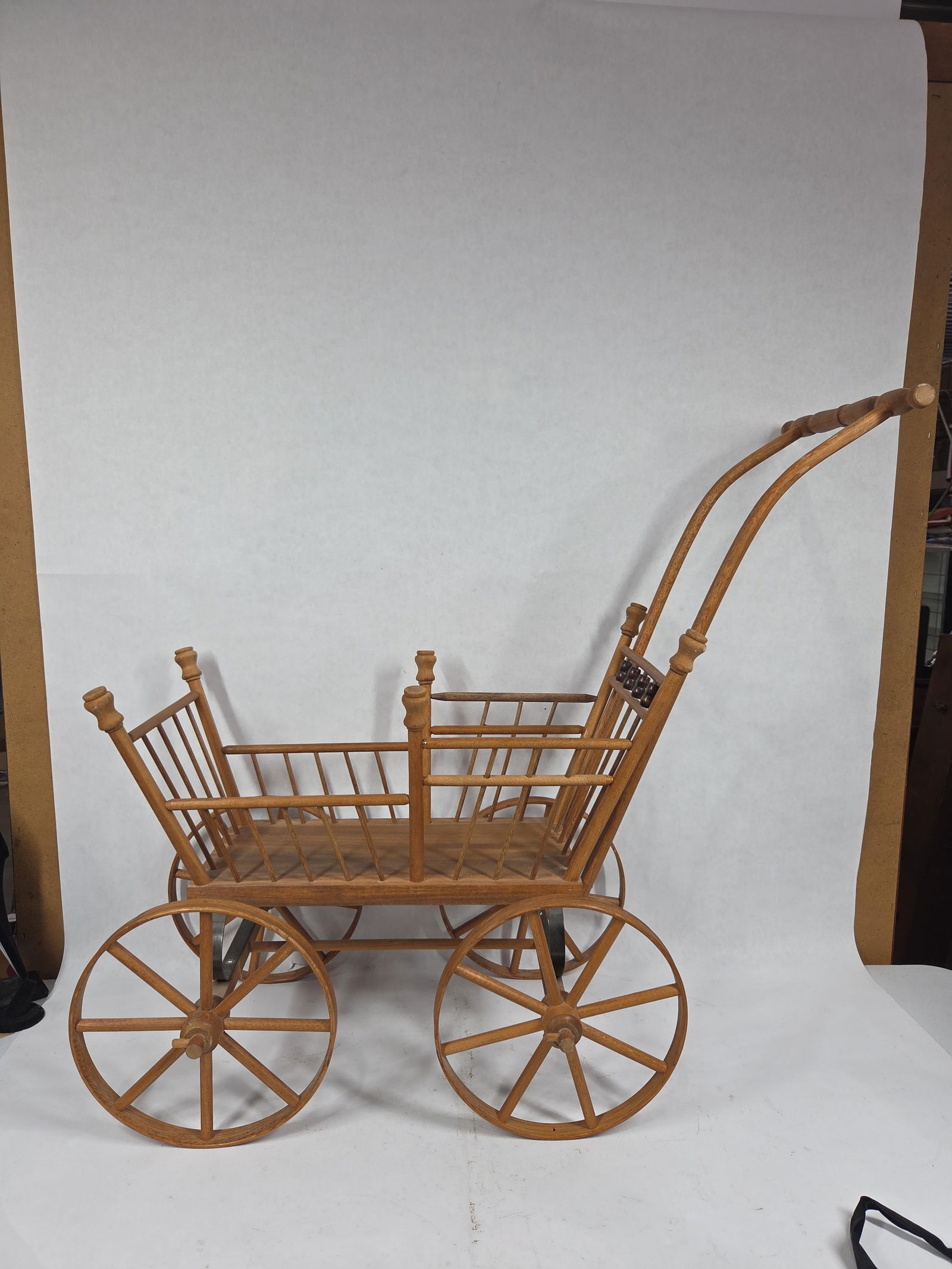 Oak French Doll Stroller: Excellent early condition with wood wheels, and body and iron springs. 30x25x10.5