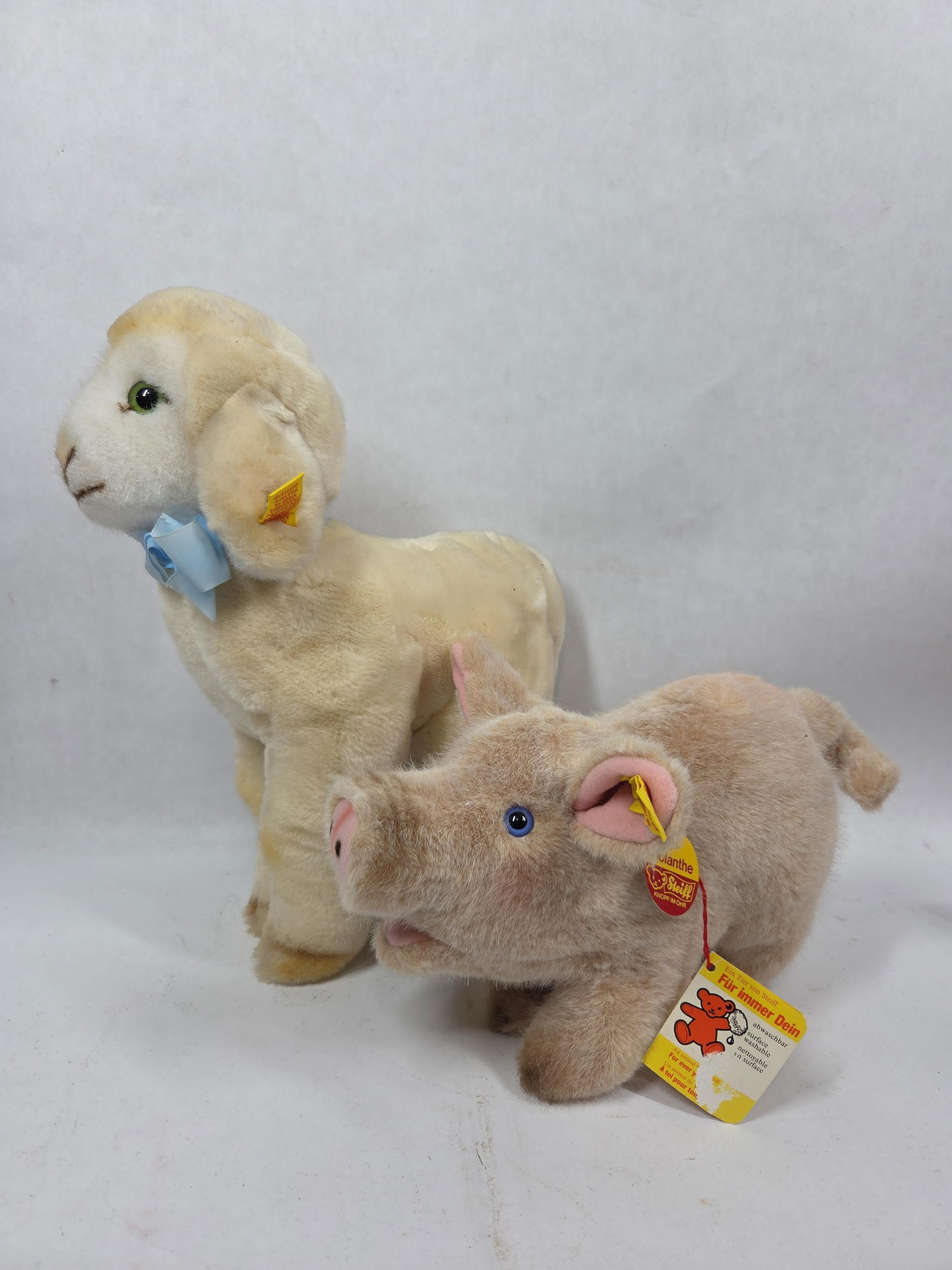 Steiff Country Lamb and Jolanthe Plush Pig: Del Monte Fluffy Lamb, from 1984. Tag number 5474/27.9 inches. Jolanthe plush pig with tag number 3810/17. Both animals are in good condition.