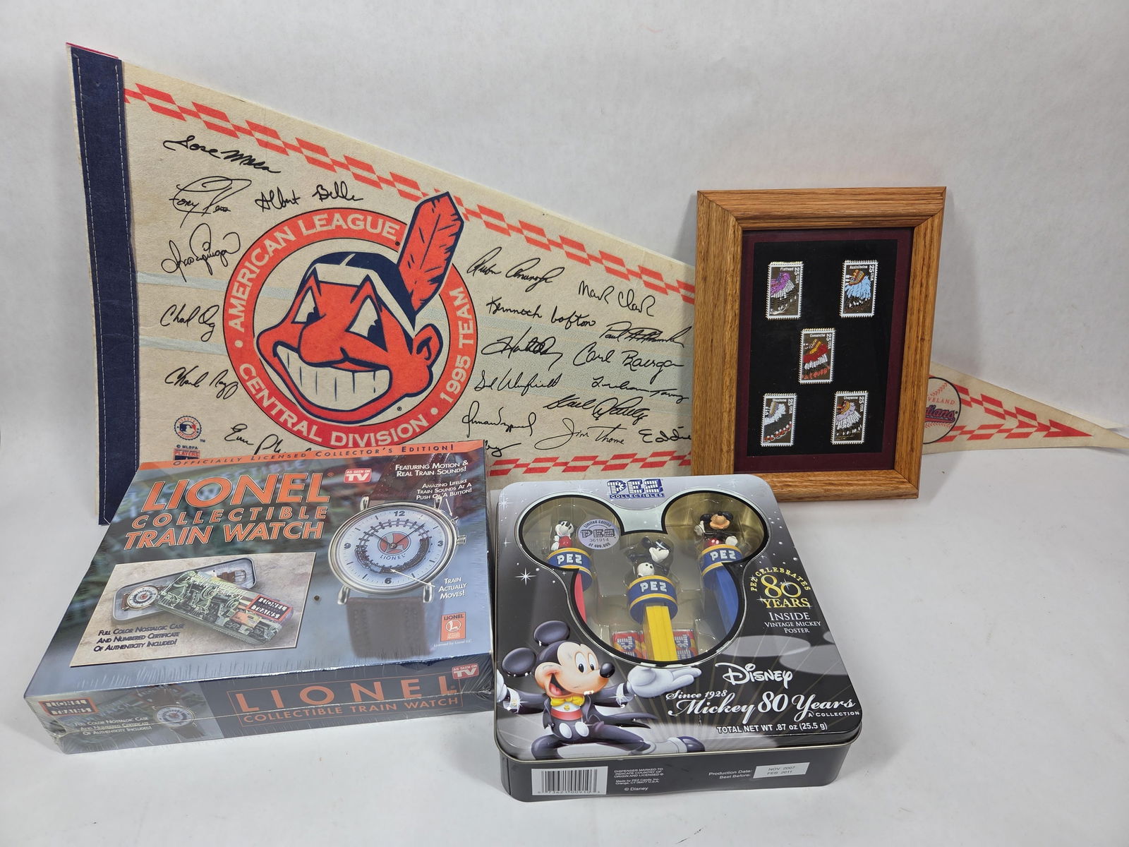Commemorative Collectible Lot Inc. Indians, Lionel, Walt Disney, Native Brass Stamp Collection: This great collectible lot includes 2 felt Cleveland Indians Pennants Framed Native American Brass Stamp Collection? Walk Disney Mickey Mouse 80 Year Ann. Pez Dispenser NOS? NOS Lionel Train Watch in