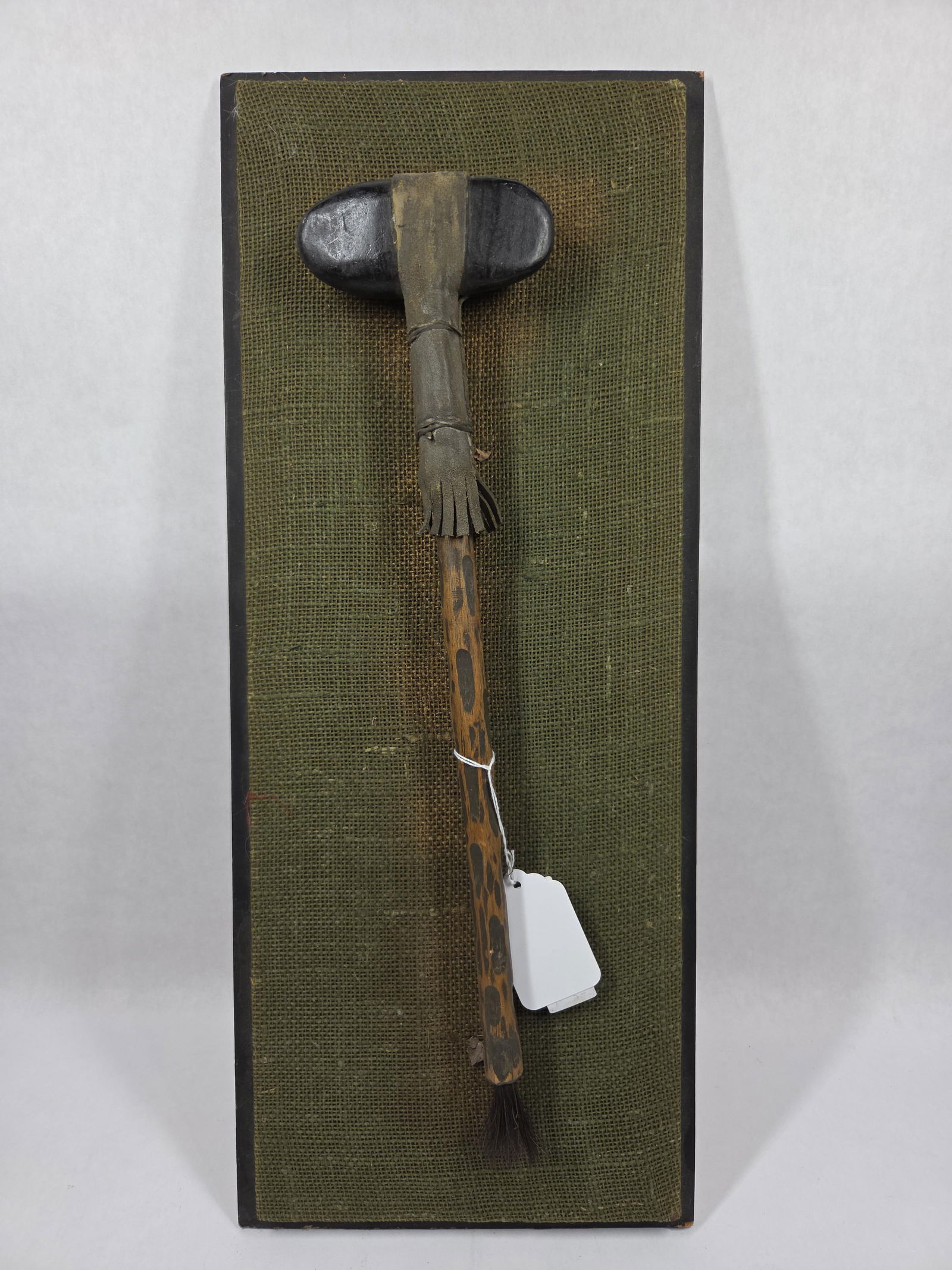 Display Native American War Club: A realistic cop featuring a wood head, decorated staff, leather banding and horsehair tail. Display is 24x9.5