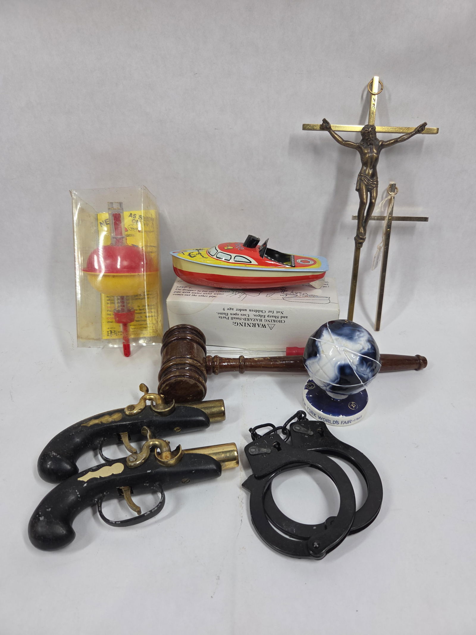 Assorted Vintage Lot of Collectibles Inc. Tin Litho toy, Sure Set Bobber, Flint Lock Lighters and Mo: This great variety lot includes a Sure Set Bobber, Tin Litho Toy Boat, Wood Gavel, 2 flint lock lighters, 2 brass crosses and 1964 Worlds Fair globe souviner