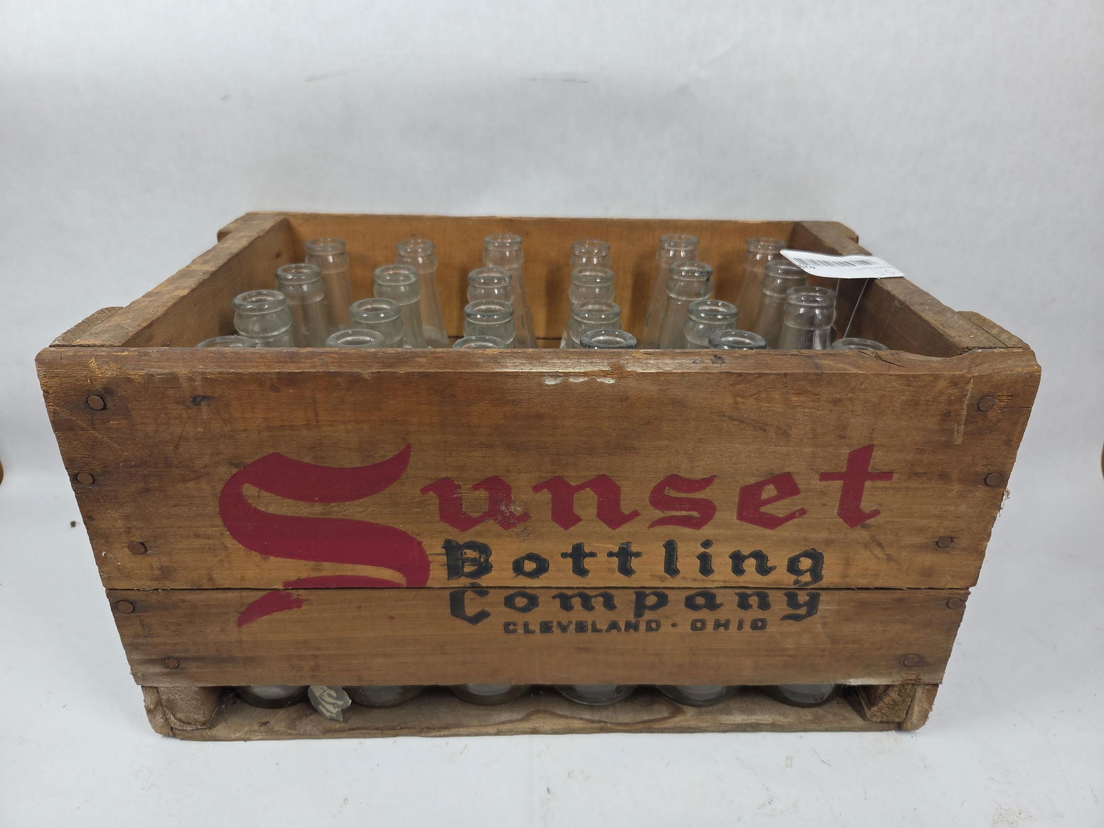 Sunset Bottling Crate & Glass Bottles: 24 bottles in stenciled wooden crate. 16x10x9. Cleveland Ohio