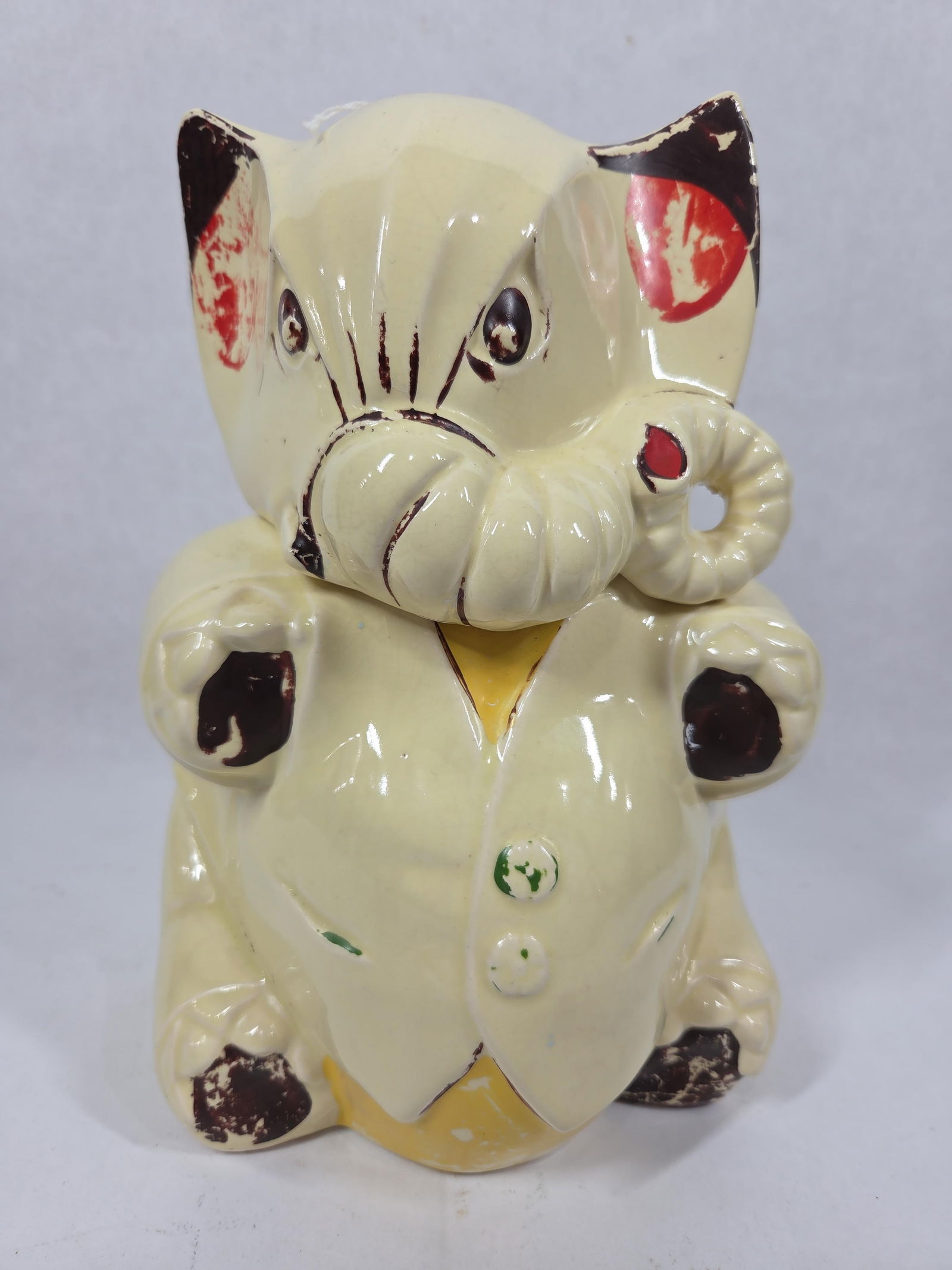 Angry Elephant McCoy Cookie Jar: Circa 1940s, showing some paint loss but in good condition with no chips or cracks. Minor crazing shows to glaze from age. 11 inches tall