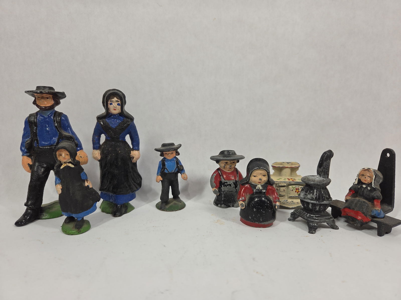 Cast Iron Dutch Figures and Mini Stoves: May show a few paint chips. Otherwise good condition. 2 to 4.5 inches