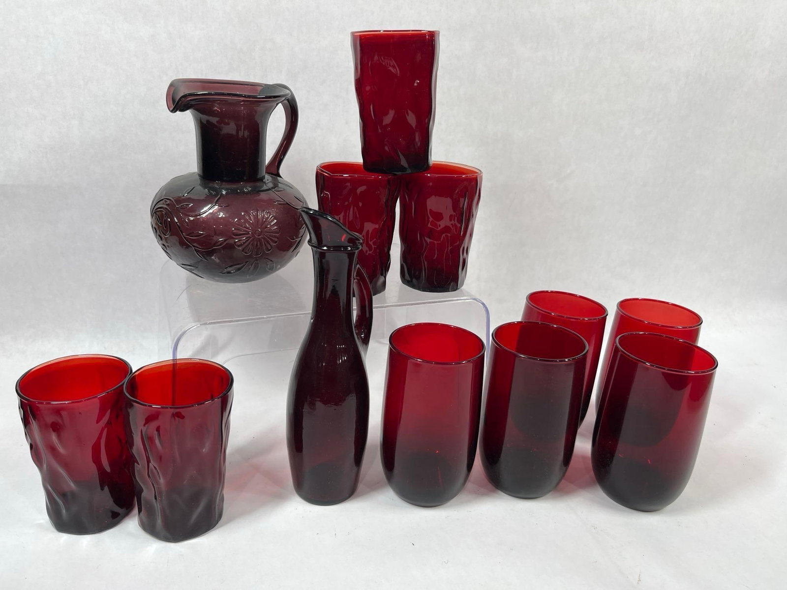 Ruby Red Waterset: Daisy pitcher with 5 glasses and a slender pitcher with 5 tumblers. All items are in good condition. 