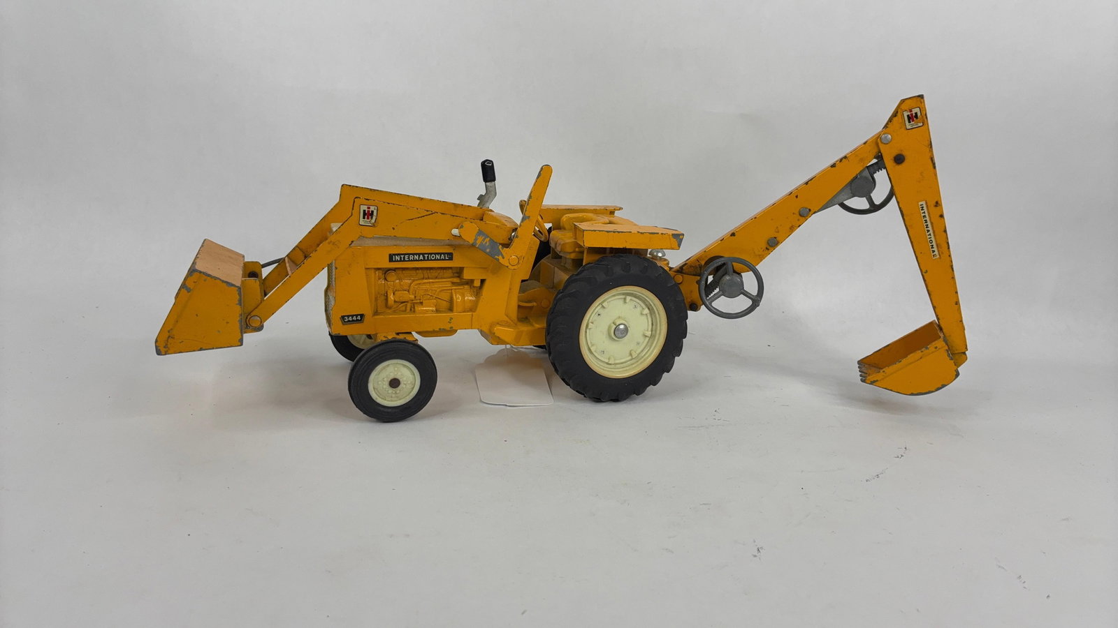 Ertl International 3444 Tractor w/ Loader and Back Hoe Industrial Farm Toy: .
