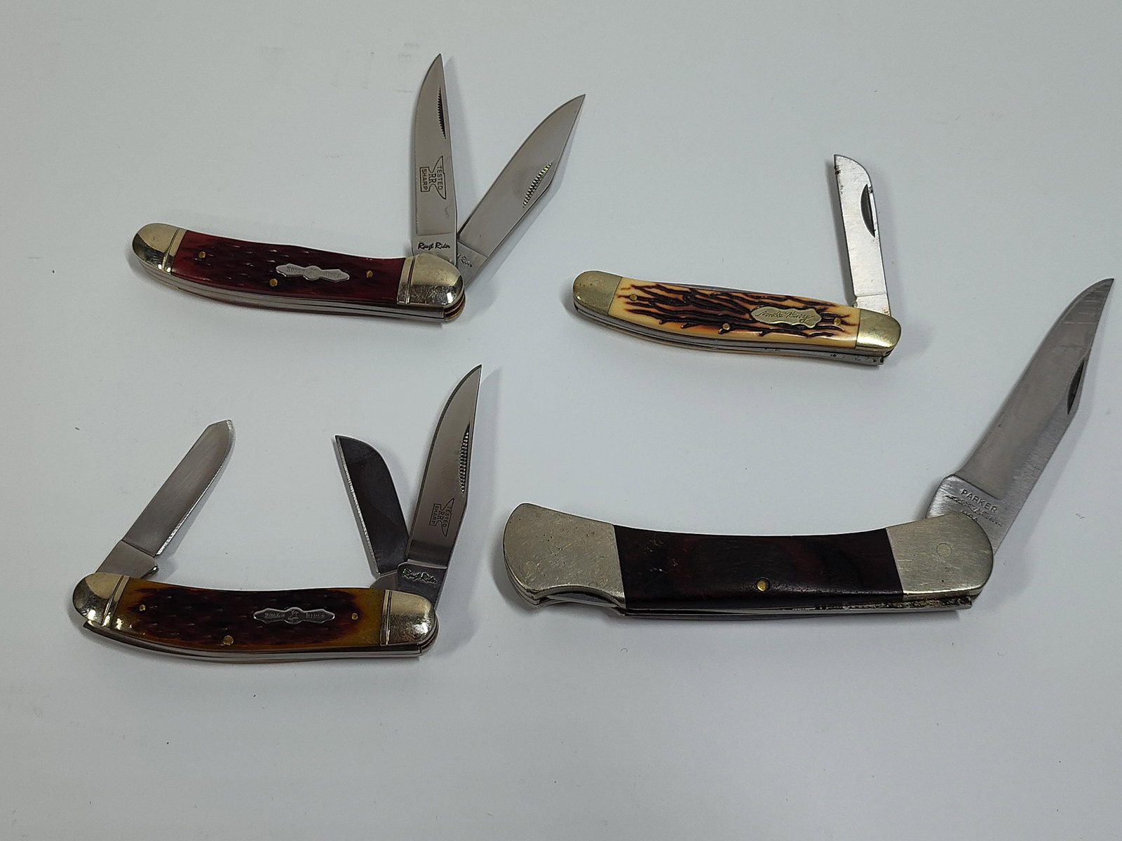 Rough Rider, Parker, and Uncle Henry Pocket Knives: 4 knives in very good condition