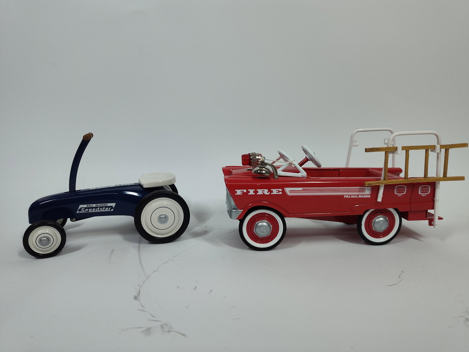 Pair of Kiddie Car Classic Pedal Cars: 1963 speedster and 1962 Sport deluxe fire truck. Each is approx 5 to 7 inches.