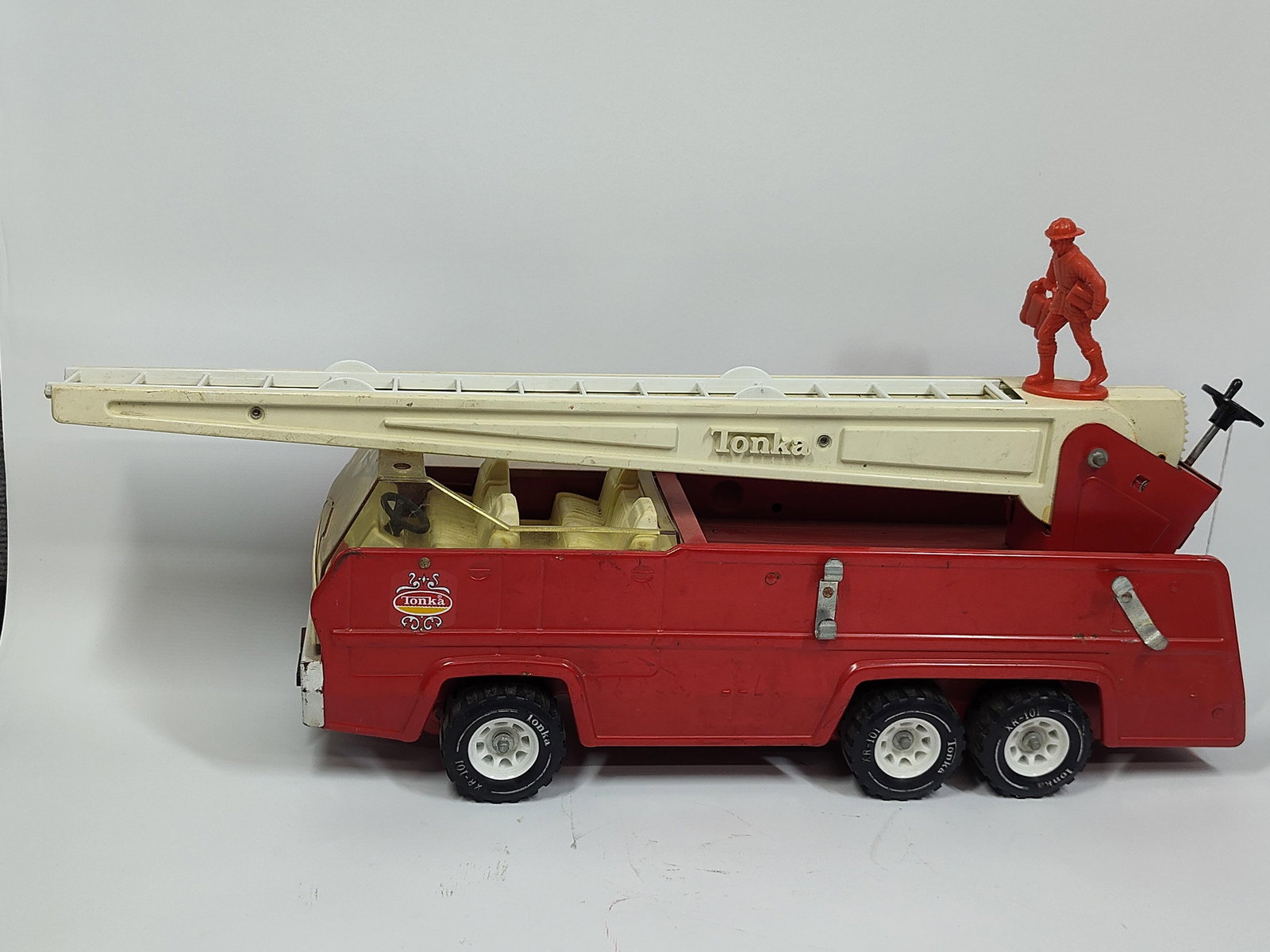 Tonka Pressed Steel Fire Truck: Good condition and includes plastic firefighter. Ladders are missing from side of truck. 24 inches