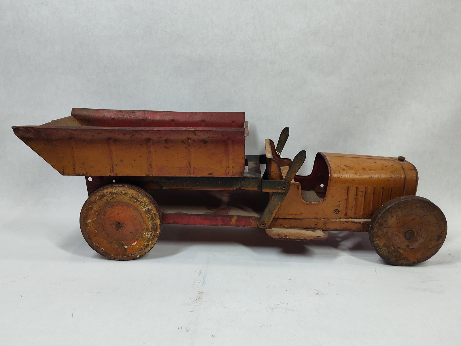 1920's Structo Scale Model Pressed Steel Dump Truck: Great overall condition with all parts moving freely as should showing soiling as well as areas of paint loss measuring 18 in L
