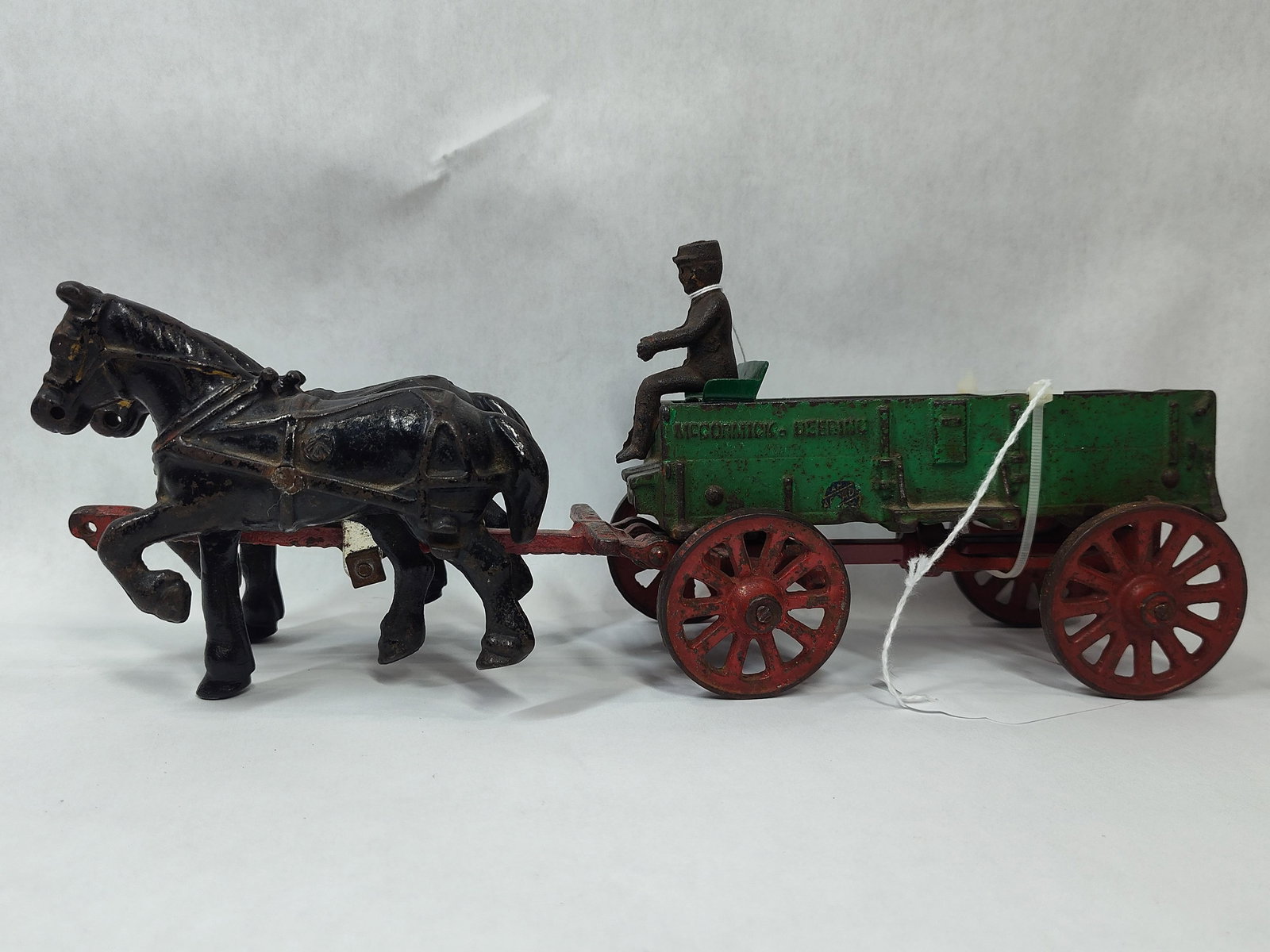 Arcade Original Cast Iron McCormick Deering Wagon, Driver and Team: great overall antique condition showing only soiling measuring 13 in L