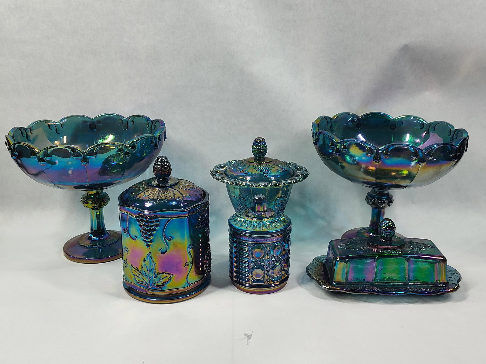 VTG Indiana Carnival Harvest Grape Pattern Biscuit Jar, Compotes, Sugar, Covered Dish and Butter Dis: this great carnival glass lot includes 2 large compote bowls measuring 85 in D, lidded pedestal candy dish, covered butter dish, lidded biscuit jar, sugar bowl and more all free from chips, cracks or