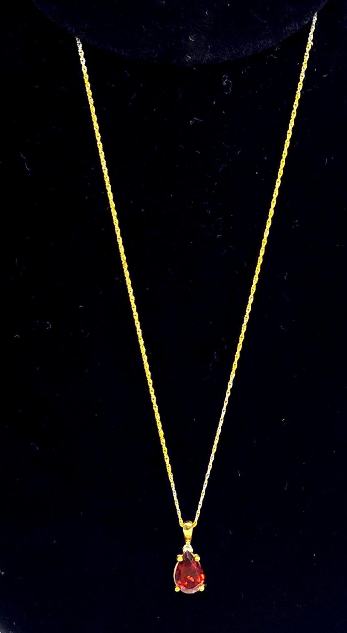 10K Gold Teardrop Garnet Necklace: Chain and pendant are both marked 10K.