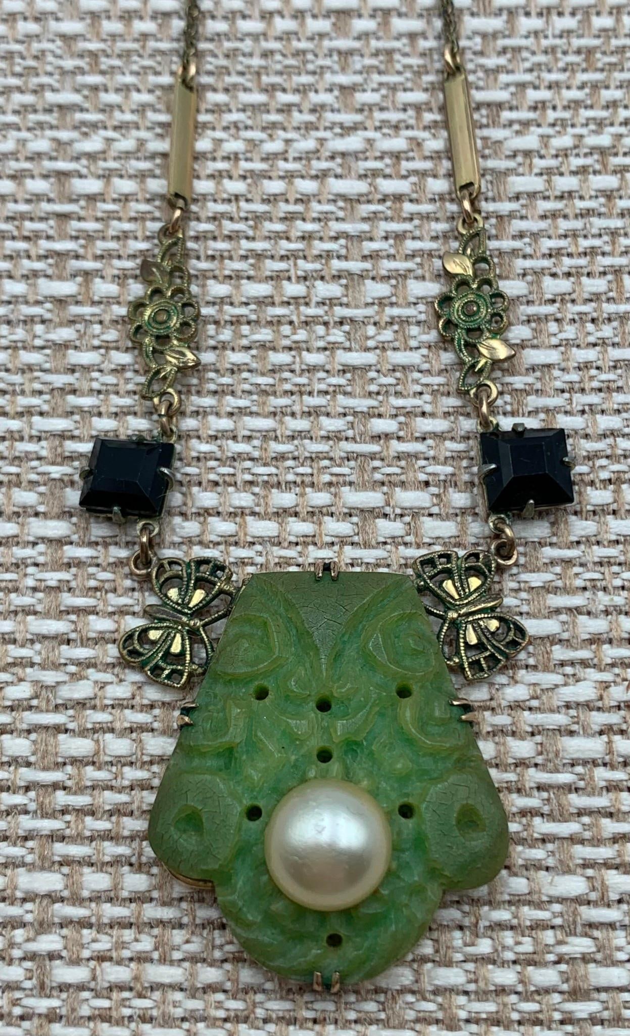 Antique Art Nouveau Carved & Pierced Created Jade Openwork Butterfly Necklace: Faceted raven glass, openwork butterfly and floral detailing, created composite Jade and faux pearl, working closure, 17 IN total length.