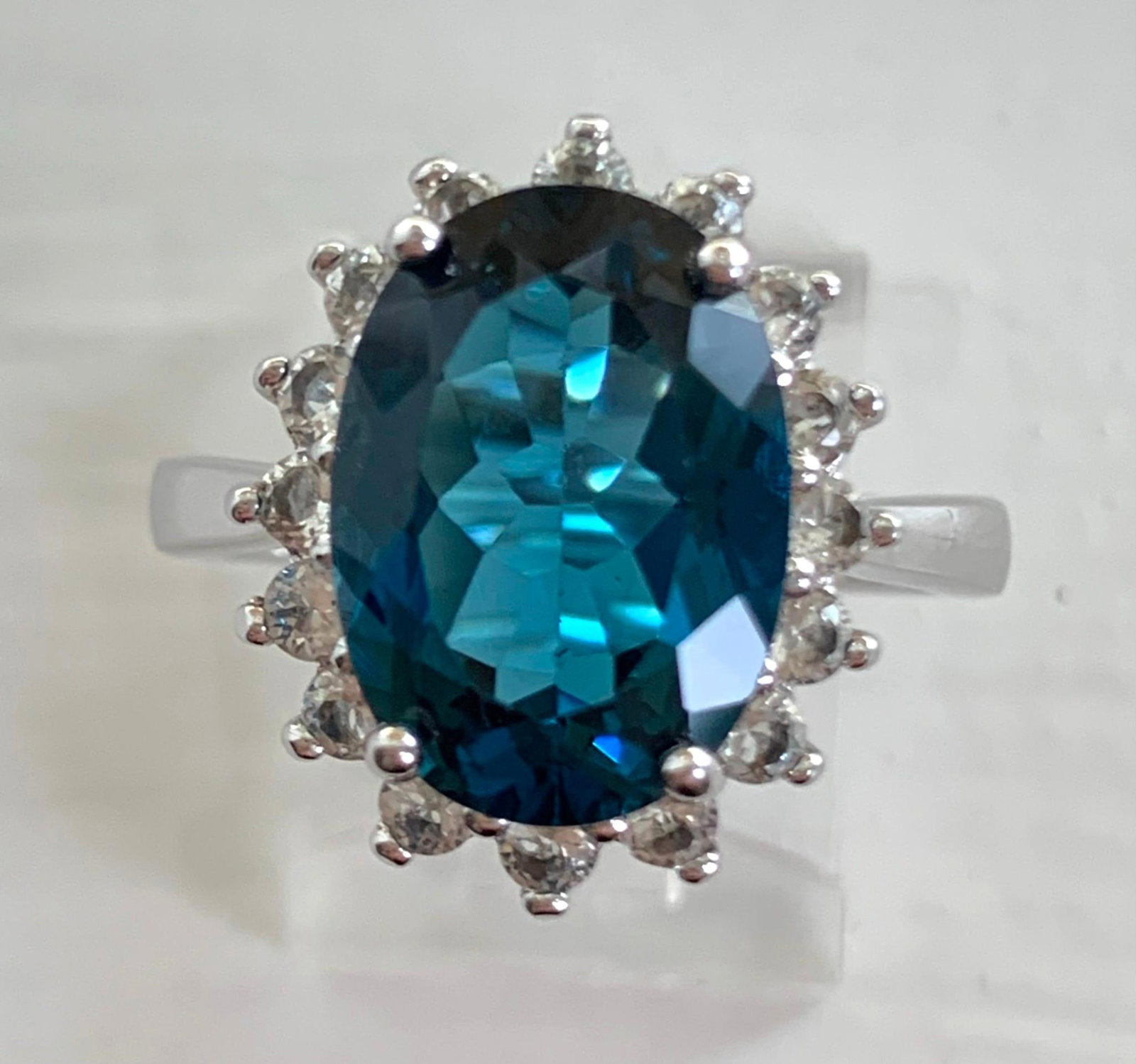 Outstanding Large 5+ Carat London Blue & White Topaz Halo Sterling Silver Cocktail Ring: 925 hallmark, 7.75 size, 6.16 gram weight, large 14x10mm (approx 5-6 carat) faceted oval London Blue Topaz, 2mm white Topaz halo, Stunning! 