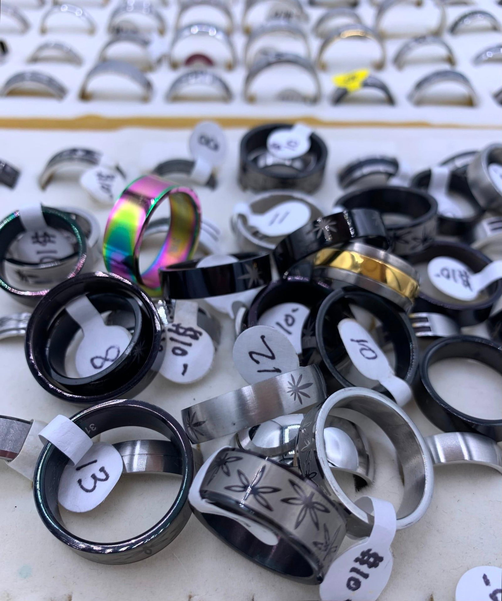166 pc NOS Fashion Jewelry Rings: Many with size and price tags attached, size 16 to 5, openwork, etched and embossed, spinner, Gothic, brushed satin, high shine, rhinestone accents and more!