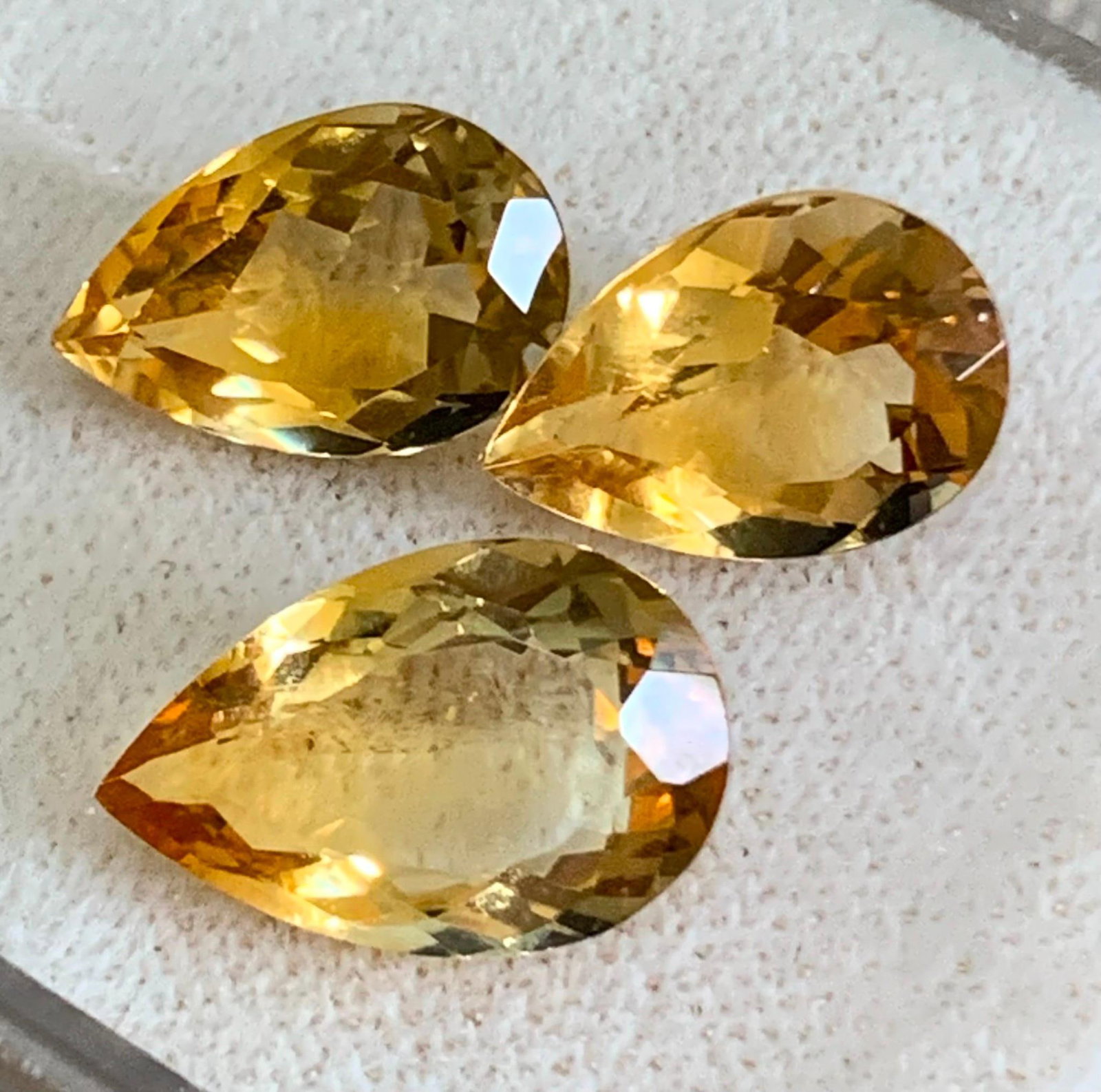 Trio LARGE Carat Unmounted Radiant Pear Shaped Imperial Topaz Loose Jewelers Gemstones: * One measures12.5x8.5mm (approx.3.5 Carat)* 2 measure 12x8mm (approx. 3 Carats per gem)Glorious?Imperial Topaz gemstones, outstanding electric sparkle in gradient sunshine hues.