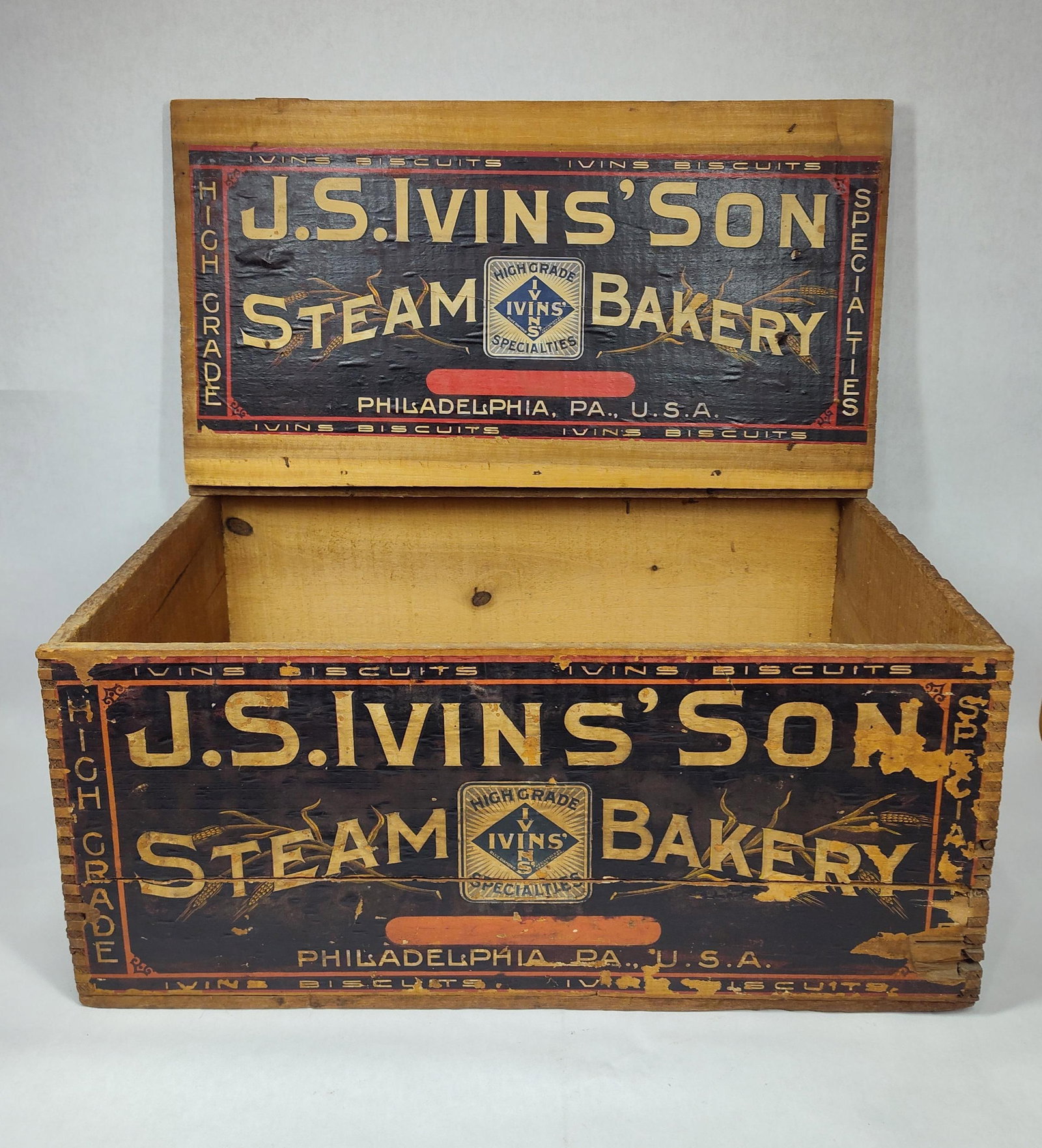 J.S. Ivins' Son Steam Bakery dovetailed box: Wire hinges on lid are severed. Dovetailed corners and original label on front. 13.5in wide 21in long 9.5in tall.