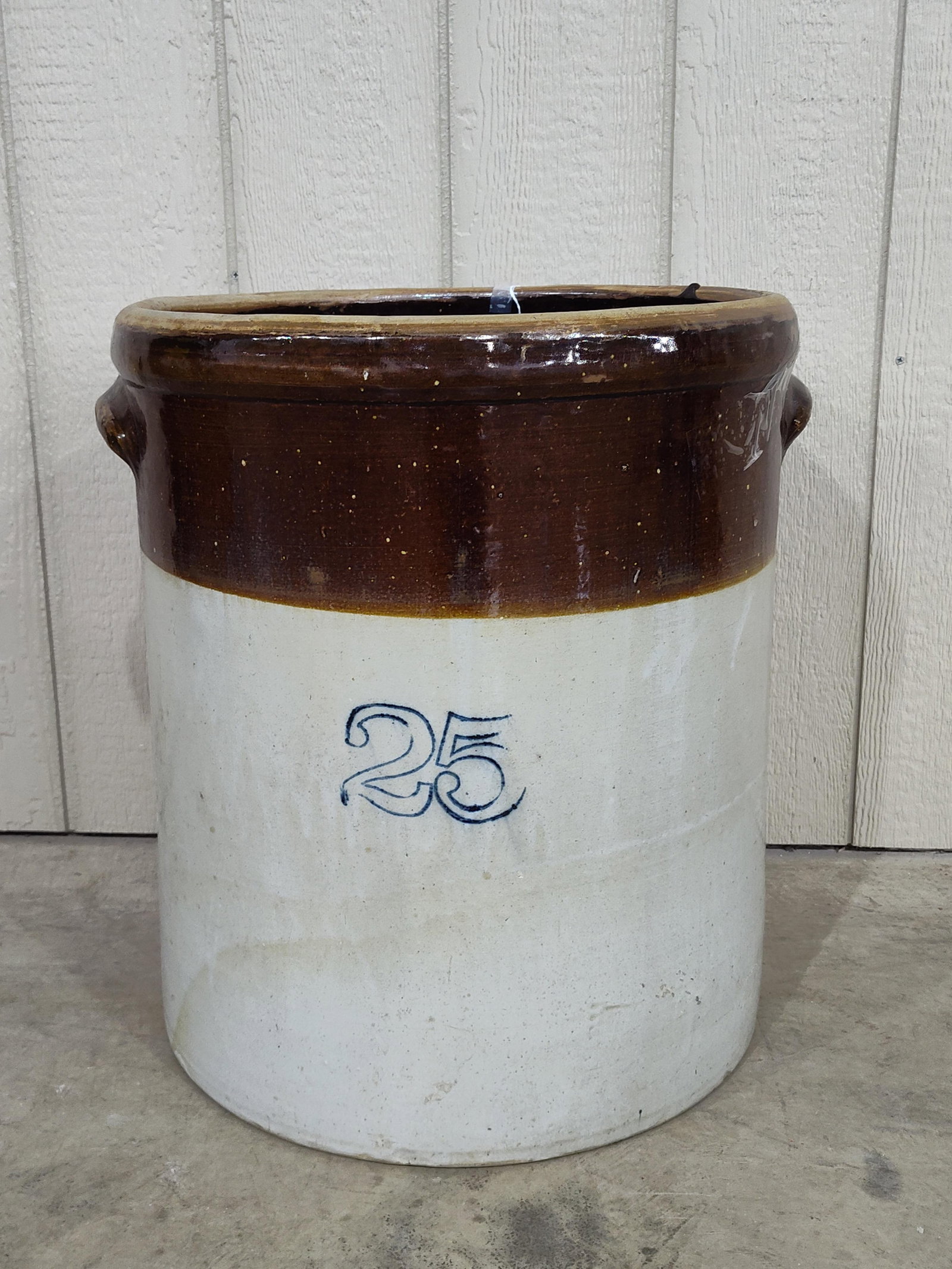 Oversized 2-toned 25gal crock: Shows a couple chips on base and a small chip on each handle. Is great looking piece and appears to be crack free. 21in diameter 22.5in tall.