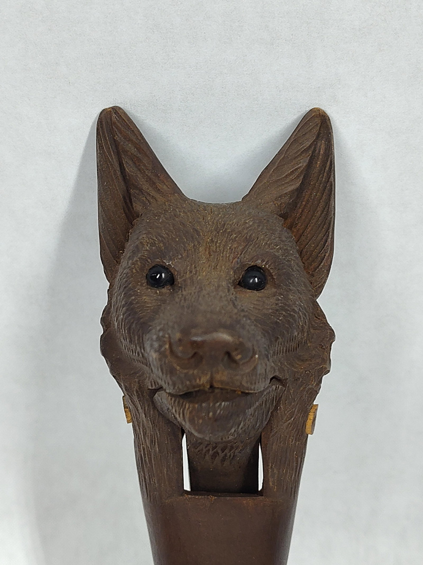 Carved Wooden Black Forest Nutcracker: With glass eyes and in great condition! 7in long.
