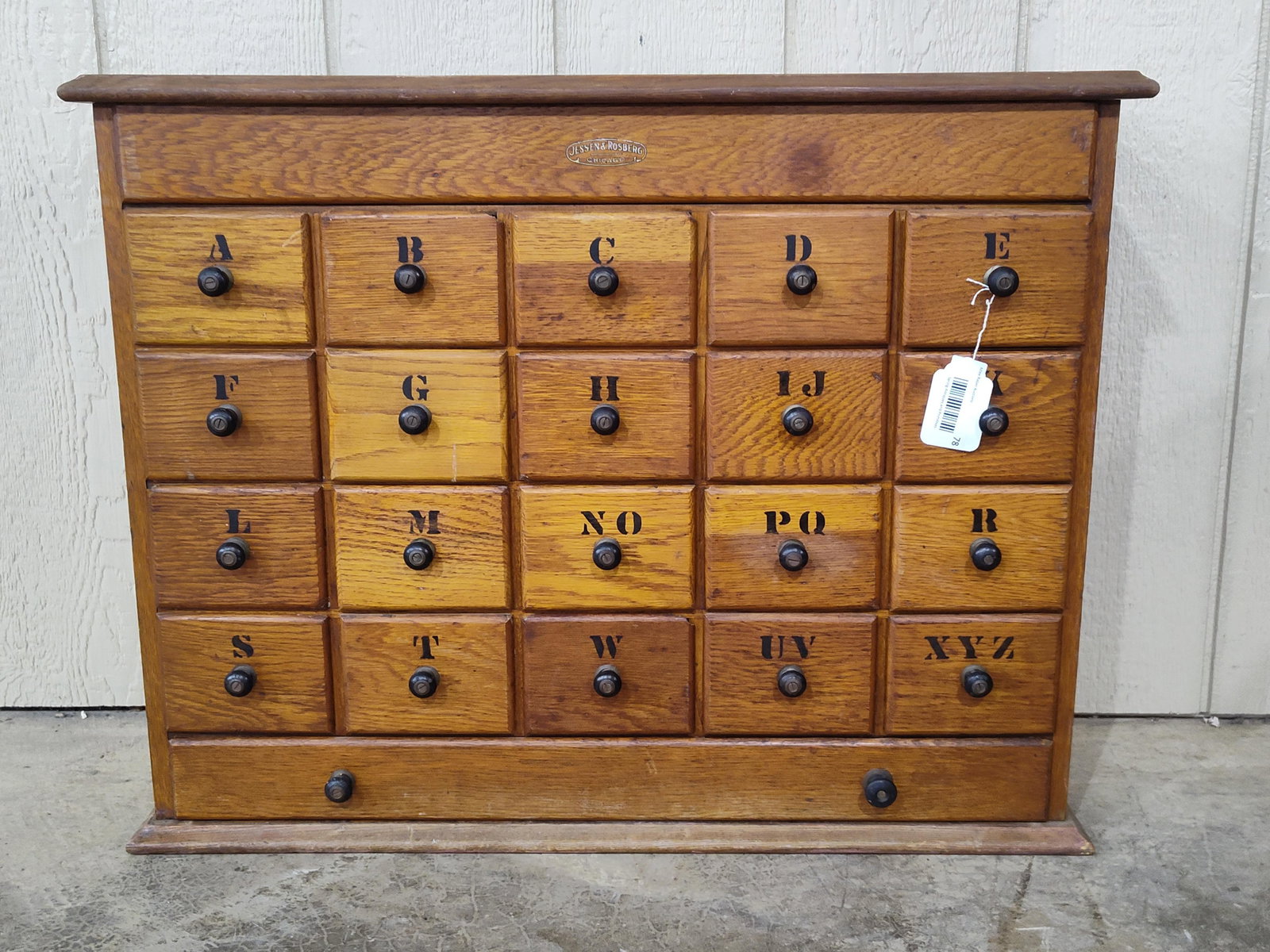 Jessen & Rosburg Oak 21-drw Storage Cabinet: Nice early Jessen & Rosburg Chicago cabinet with 21 drawers and a storage compartment on top with hinged lid access. Few of drawer fronts have chipped corners. 30in wide 9.5in deep 24in tall.