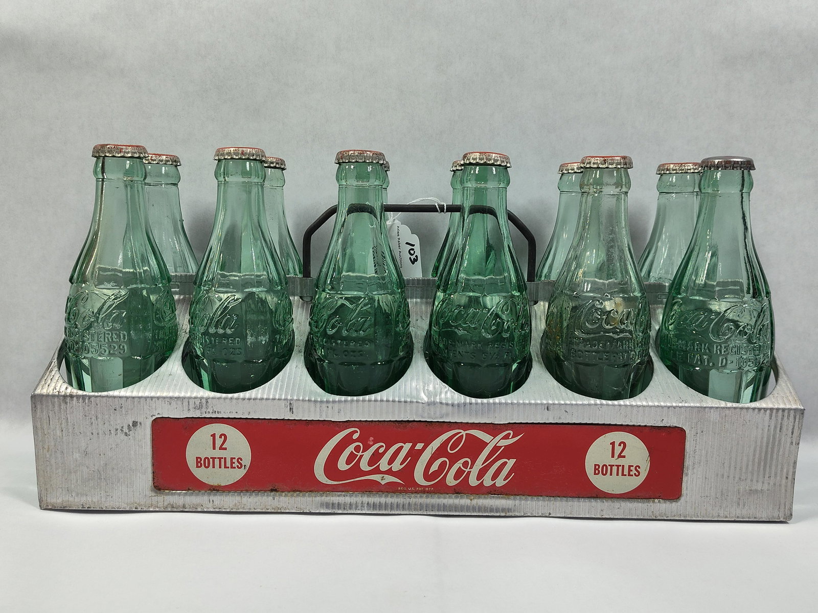 Coca-Cola 12-pack Carrier with Bottles: Nice aluminum 12 pack carrier with 12 matching bottles. 16.25in long.